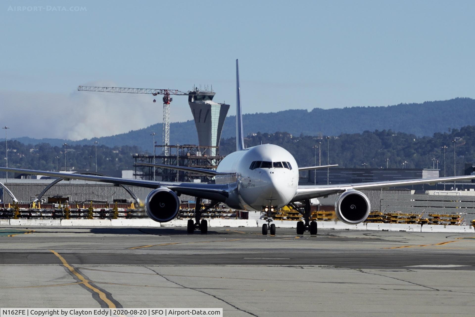 N162FE, 2018 Boeing 767-3S2F(ER) C/N 43632, You can see smoke from the Santa Cruz fire behind the aircraft. SFO 2020.