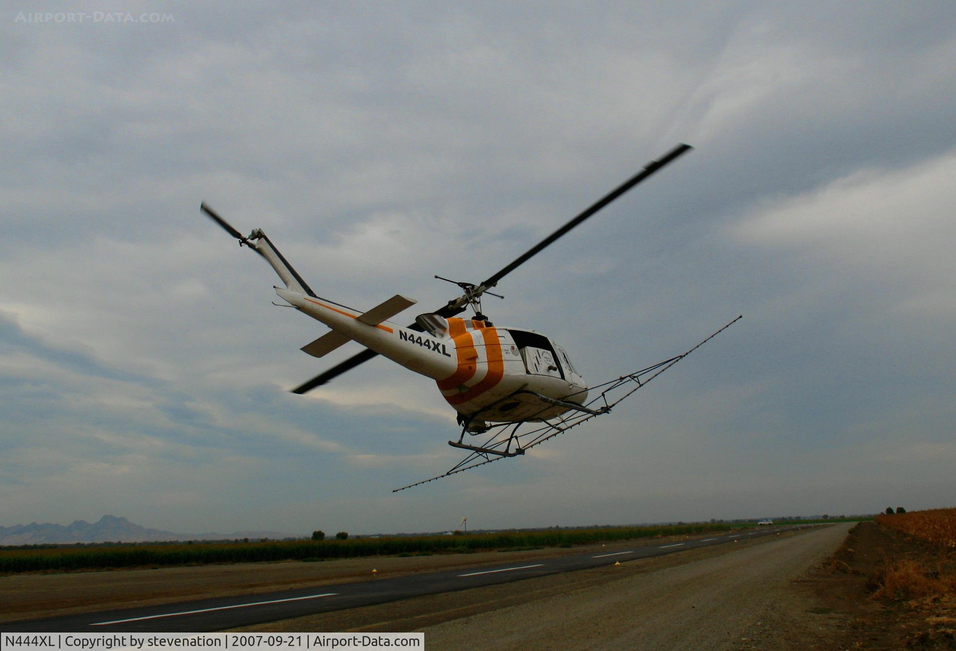 N444XL, 1967 Bell UH-1H Iroquois C/N 9358, Pacific Valley Aviation Bell UH-1H heads out for crop spraying job from Arbuckle, CA Lone Star Road home base (ex 67-17160)