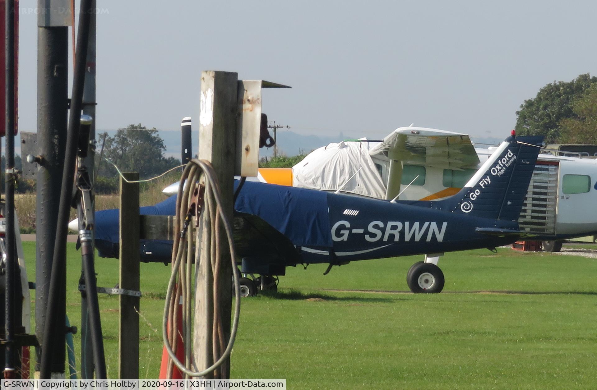 G-SRWN, 1981 Piper PA-28-161 Cherokee Warrior II C/N 28-8116284, Parked & covered behind the fuel pump at Hinton-in-the-Hedges airfield