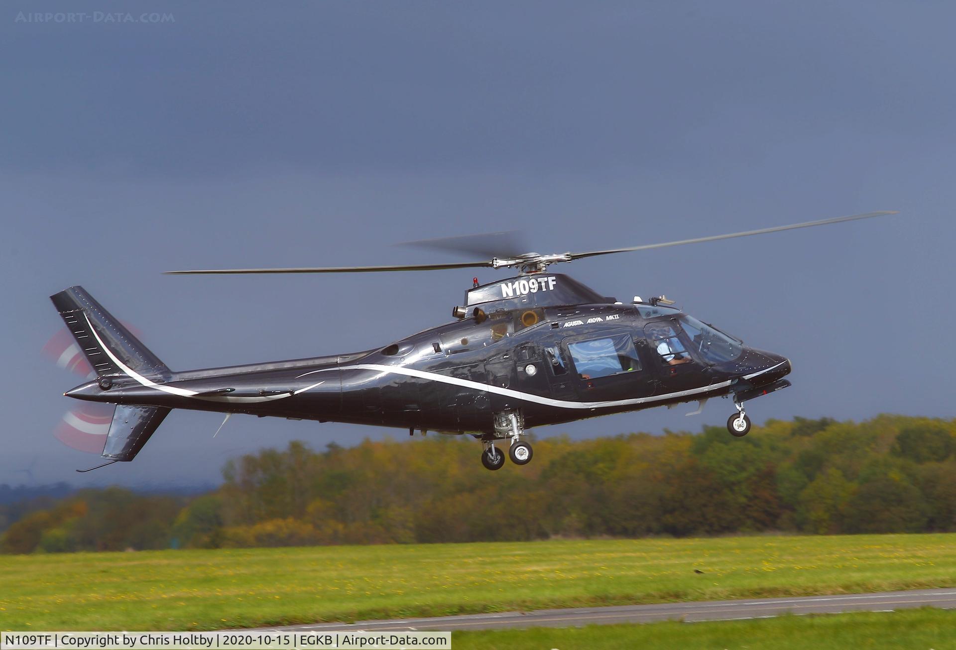 N109TF, 1985 Agusta A109A II C/N 7328, Agusta A109 landing at Biggin Hill against a very stormy sky