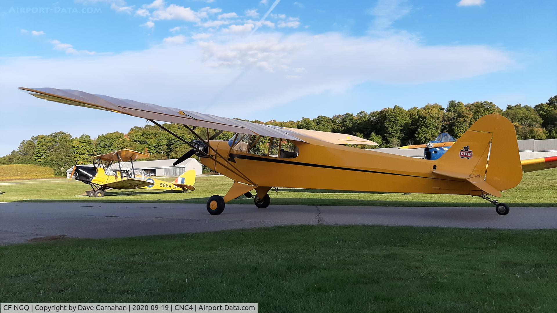 CF-NGQ, 1945 Piper J3C-65 Cub Cub C/N 14816, CF-NGQ at Guelph Airpark. Note the lovely Tiger Moth DH82-C in the background
