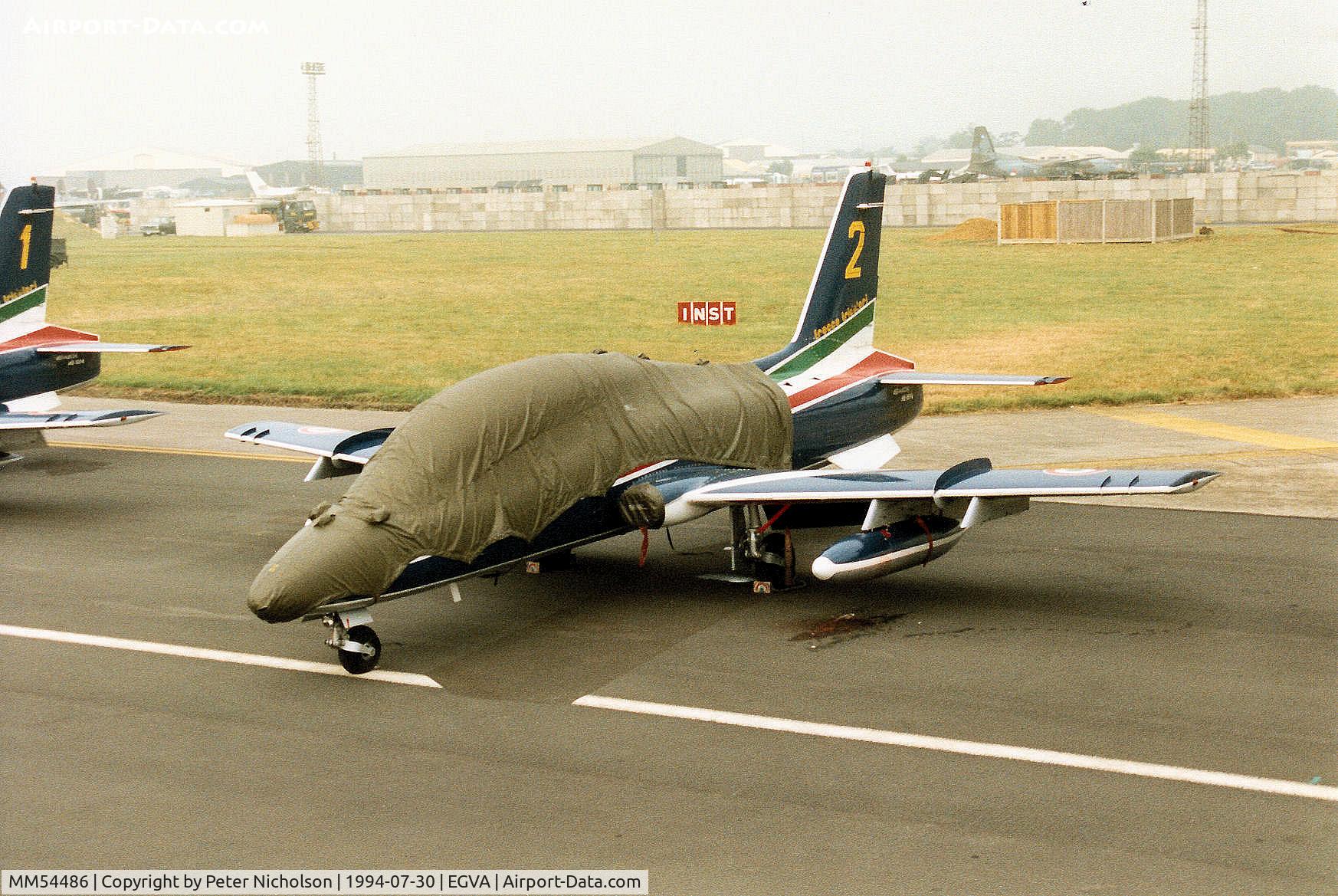 MM54486, Aermacchi MB-339PAN C/N 6683/078/AD015, MB-339A number 2 of the Italian Air Forces Frecce Tricolori display team on the flight-line at the 1994 International Air Tattoo at RAF Fairford, Gloucestershire.