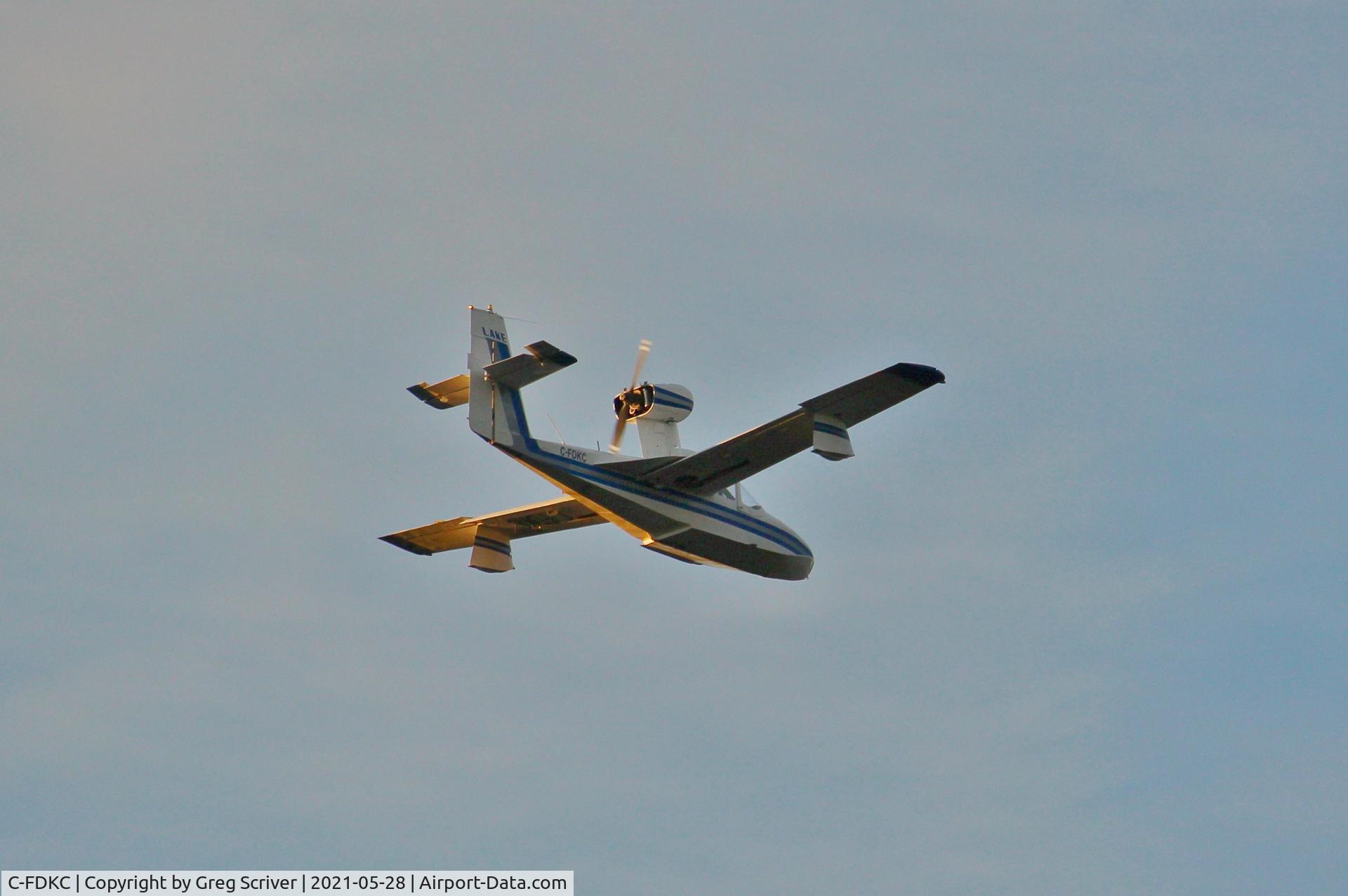 C-FDKC, 1964 Lake LA-4-180 Amphibian C/N 281, Flying over the Ottawa River during a golden sunset.