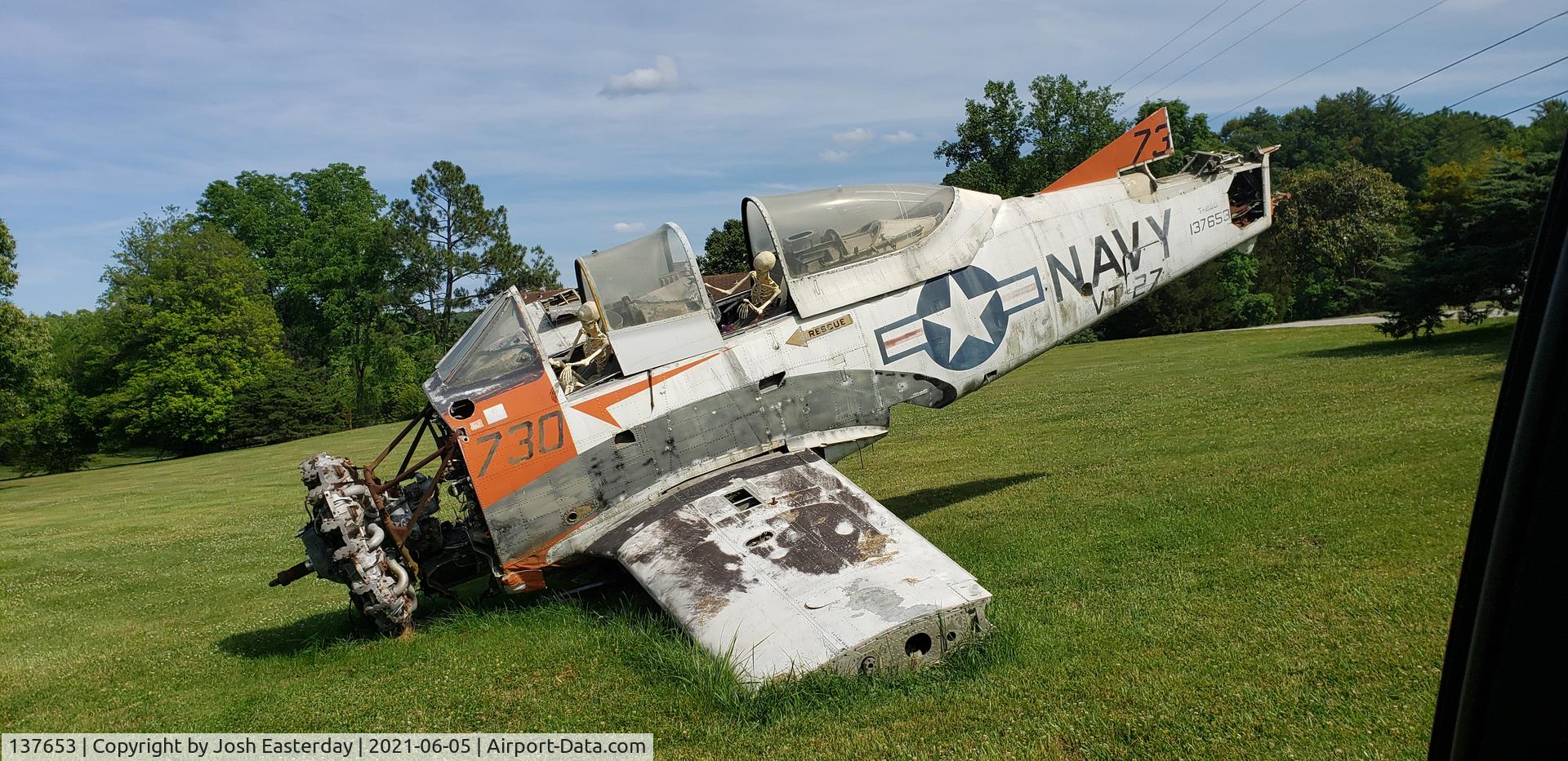 137653, North American T-28B Trojan C/N 200-16, Taken by me from the road. In a front yard in Morgan County Tn. On the corner @ Hw 62 and 1850 Fairview Rd. Oliver Springs Tn. 37840. I would guess its for attention for what appears to be a machinery business behind the home.