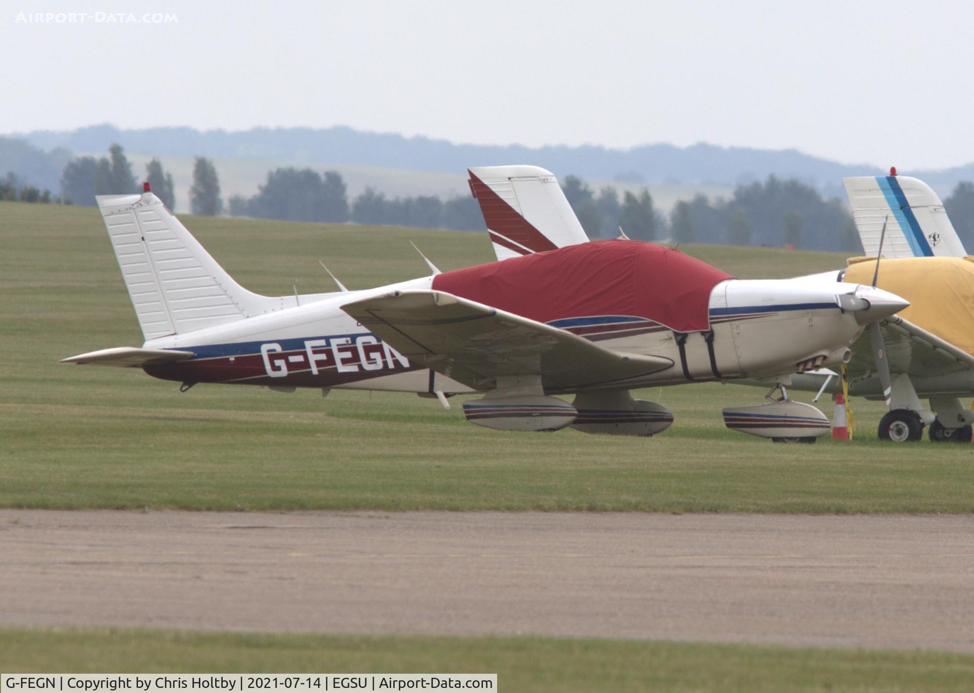 G-FEGN, 1984 Piper PA-28-236 Dakota Dakota C/N 28-8411030, Parked and covered at Duxford Airfield, Cambs. Group owned in Buntingford.