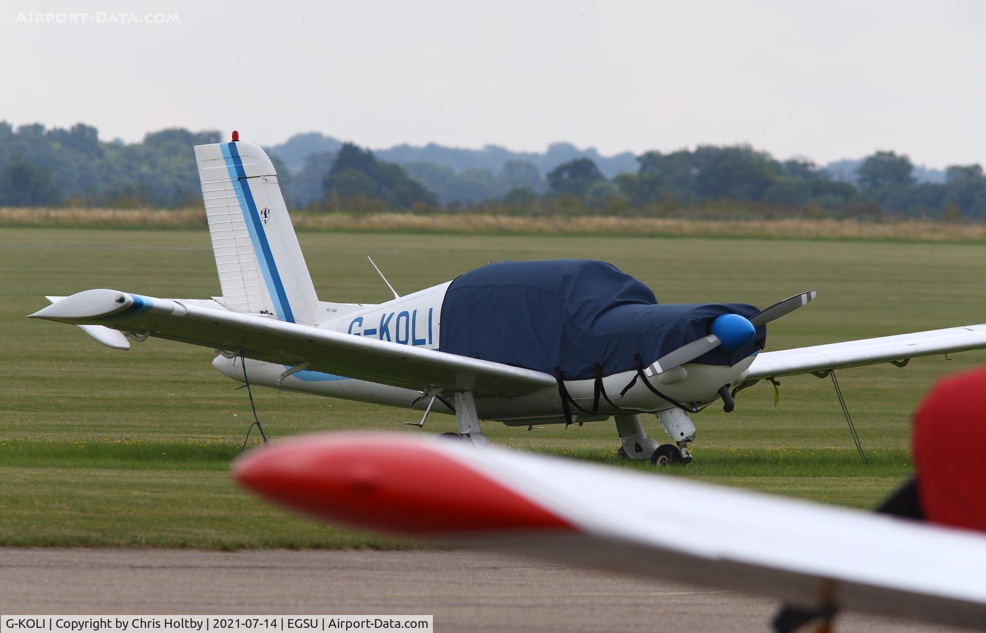 G-KOLI, 1990 PZL-Okecie PZL-110 Koliber 150 C/N 03900038, Parked and covered at Duxford