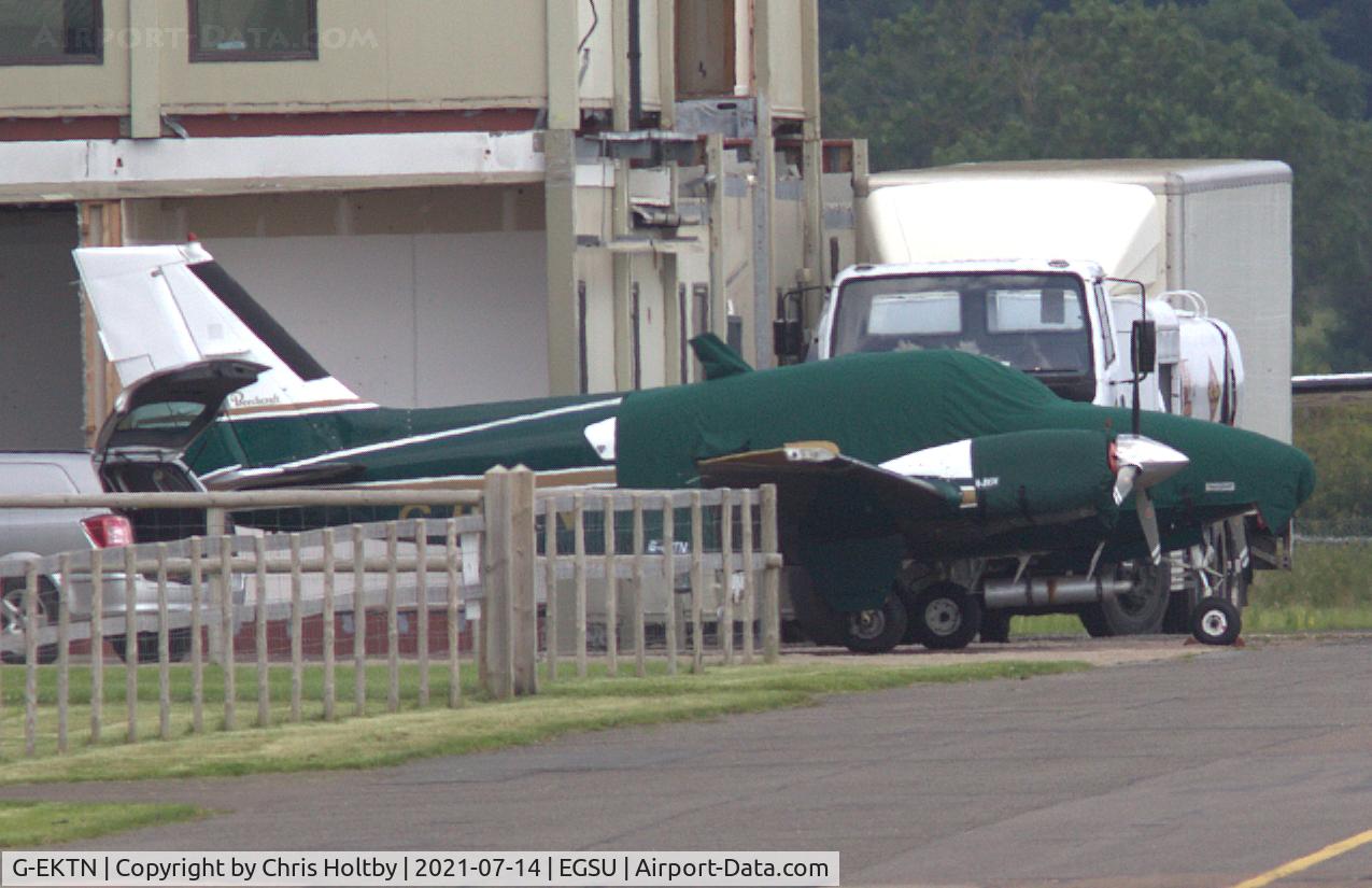G-EKTN, 1979 Beech 95-B55 Baron Baron C/N TC-2259, 1979 Baron parked and covered at North Weald