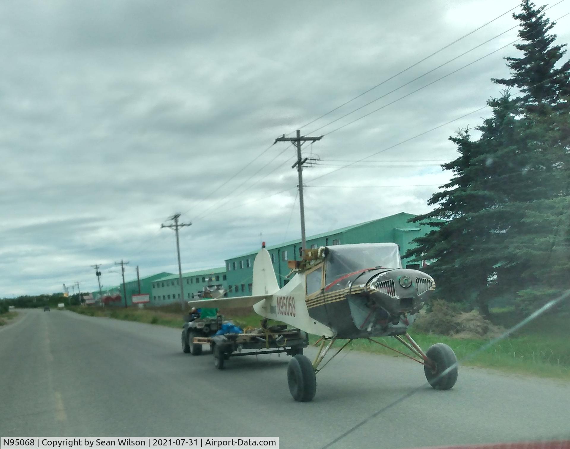 N95068, 1946 Taylorcraft BC12-D C/N 9468, Wingless, being towed by 4-wheeler on Alaska Peninsula Highway. Was being taken to AGS cannery yard, Naknek AK.