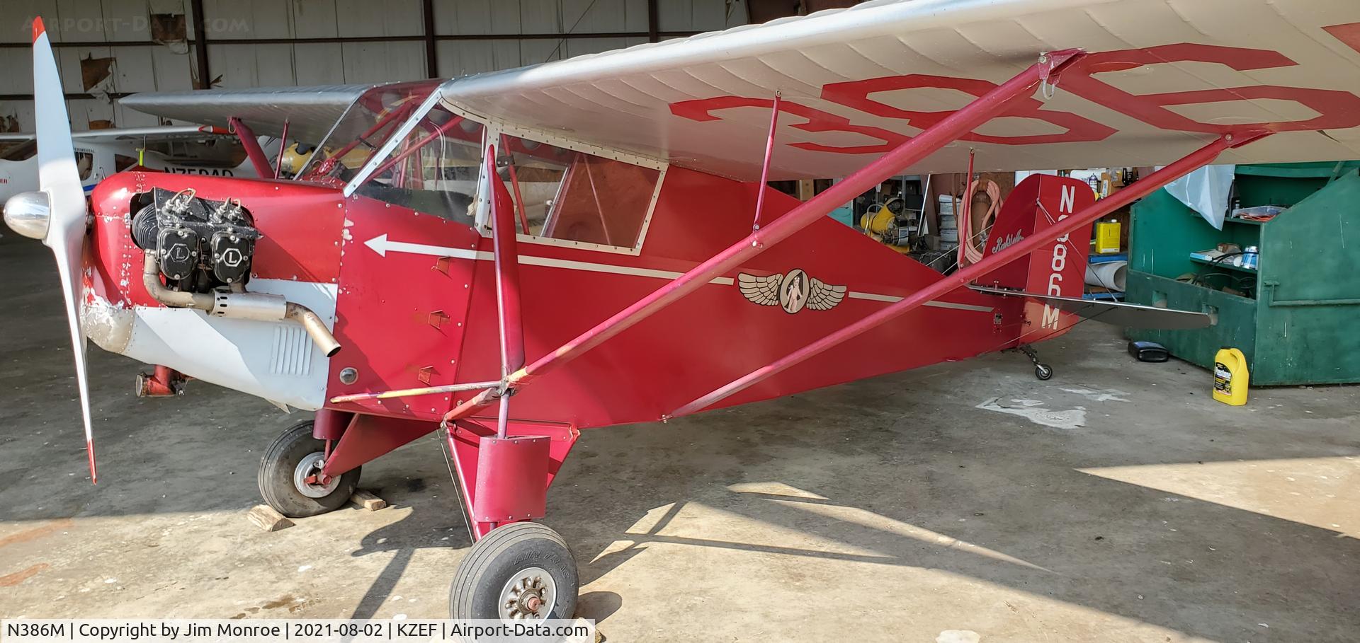 N386M, 1990 Witt Leroy A SLP C/N 102, Sitting in the front of a large hangar, sharing space with a Luscombe and a J3 among others.