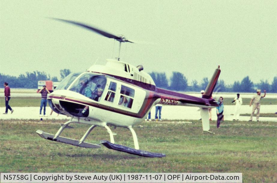 N5758G, Bell 206B C/N 3141, I was on holiday in Florida from the UK and visited the Miami Air Show at Opa-Locka Airport on Saturday 7th November 1987. N5758G is pictured making one of many short pleasure flights throughout the day.