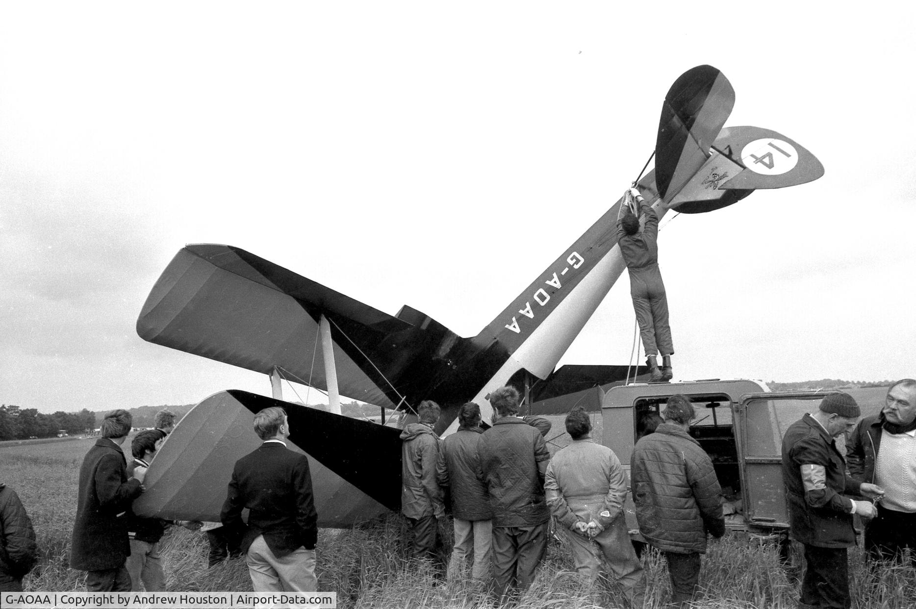 G-AOAA, 1942 De Havilland DH-82A Tiger Moth II C/N 85908, This aircraft had been flying with a 'wing-walker' in very gusty weather at Audley End air show circa 1970/71. The plane was caught by the wind as it taxied after the display and flipped. Bill Ison, then CFI at Cambridge Flying Group is far right in shot.