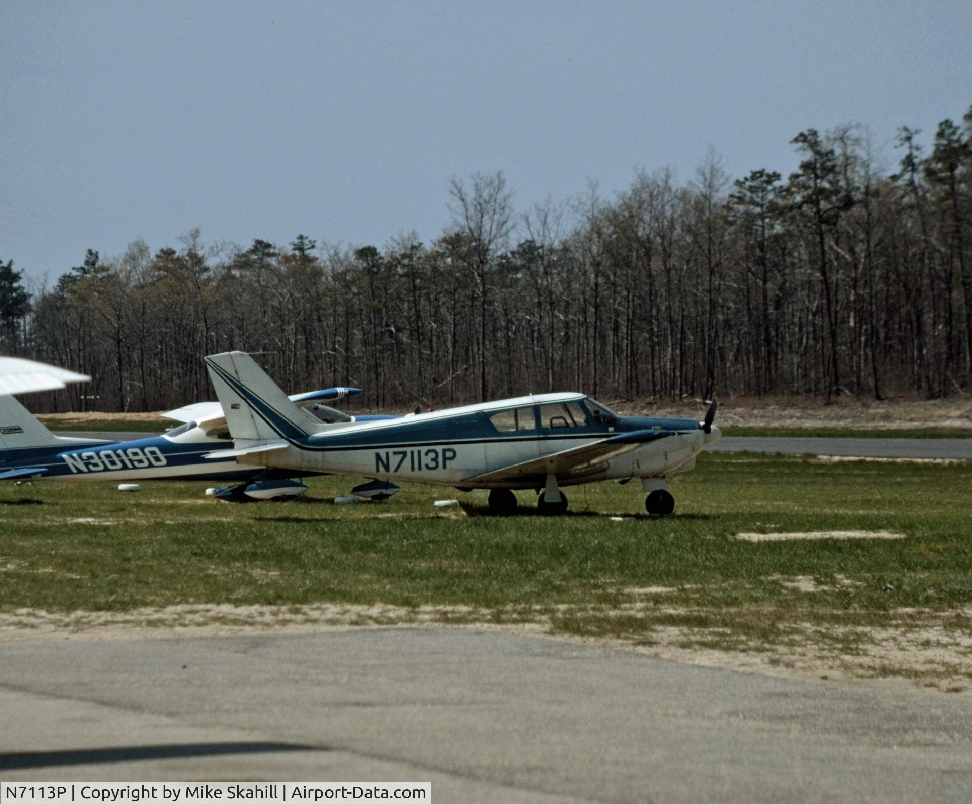 N7113P, 1960 Piper PA-24 Comanche C/N 24-1879, Parked Airport Unknown.