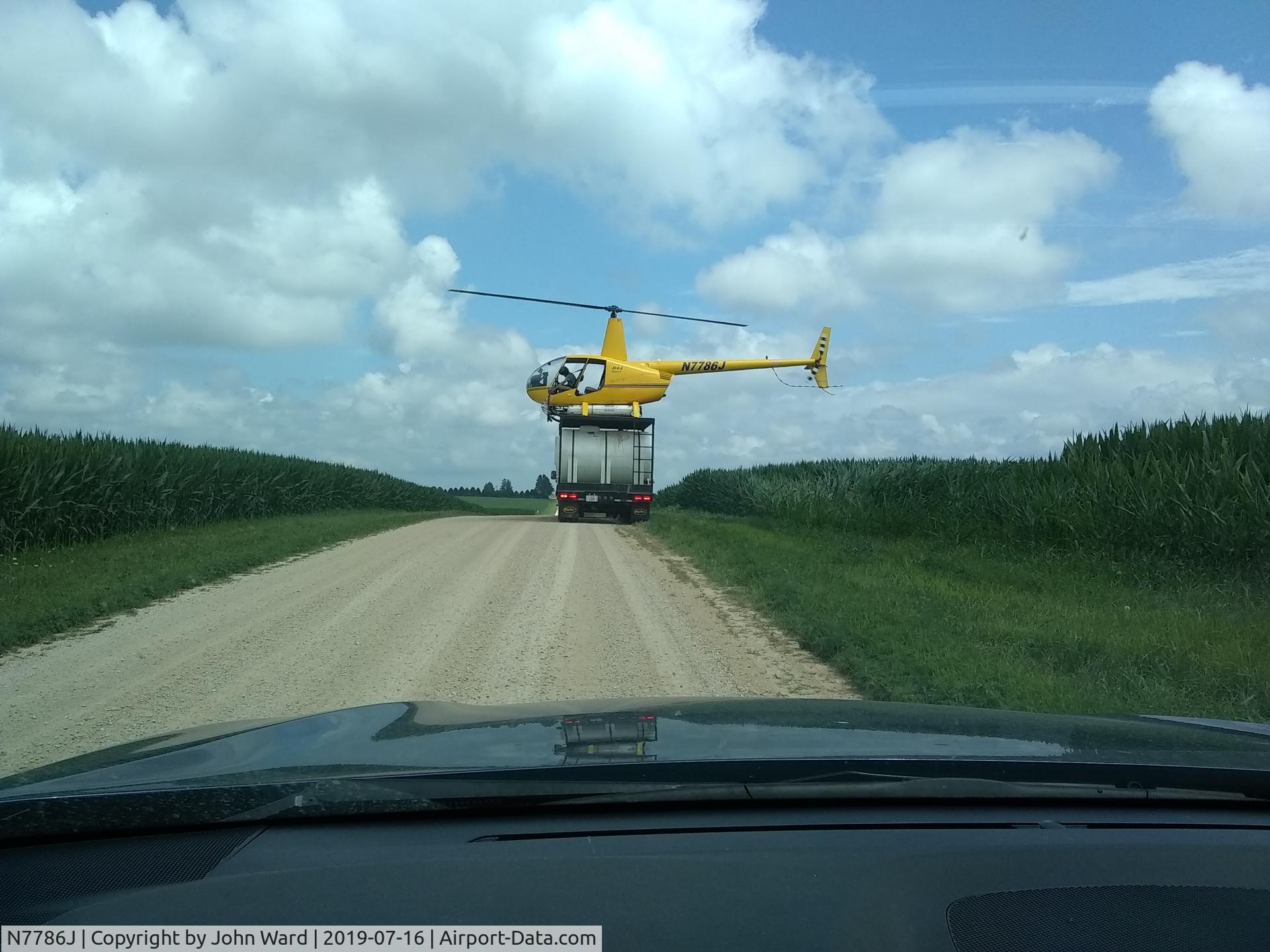 N7786J, 1998 Robinson R44 C/N 0521, Refilling from top of truck. Brick Church Road, Ogle County Illinois