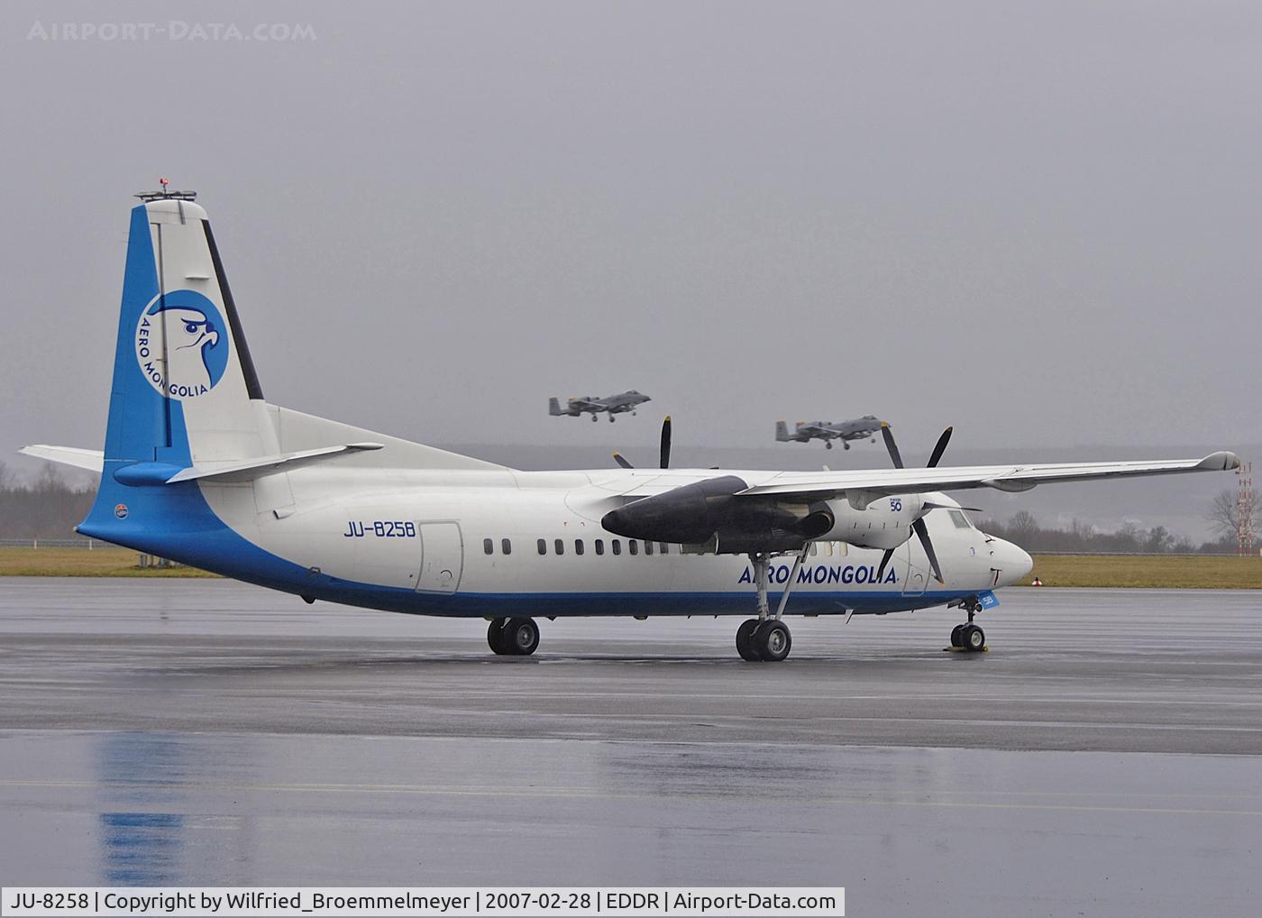 JU-8258, 1992 Fokker 50 C/N 20258, Aero Mongolia - In for maintenance at Contact Air Technik Saarbruecken (Germany). Also to see are two USAF A-10 from ETAD - Spangdahlem Air Base.