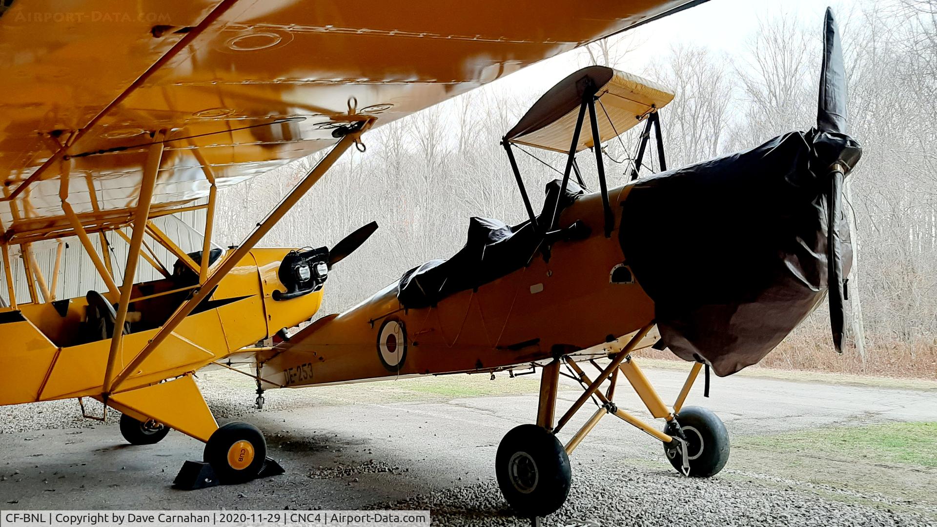 CF-BNL, 1944 De Havilland DH-82A Tiger Moth II C/N 85299, DE-253 with the wings removed, sitting along side a 1945 Piper J3 Cub