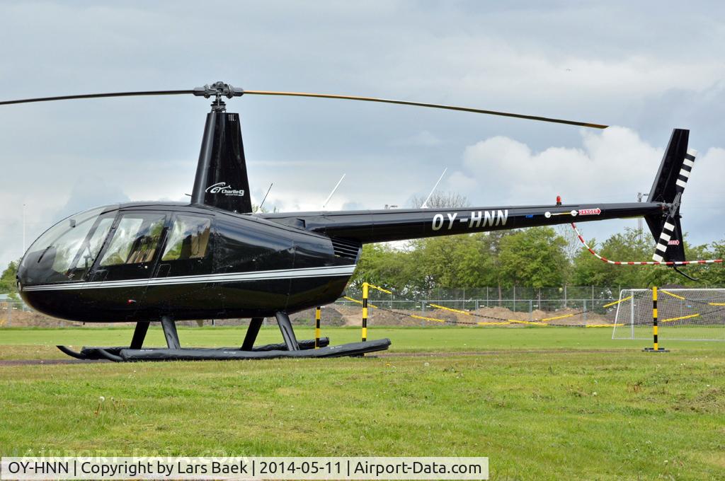 OY-HNN, 2008 Robinson R44 Clipper II C/N 12154, Resting on the field at Dragoer Football Club