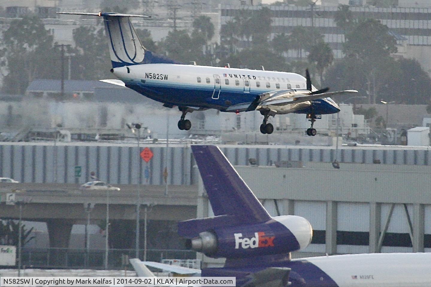 N582SW, 1999 Embraer EMB-120ER Brasilia C/N 120350, SkyWest/United Express Embraer EMB-120ER Brasilia, N582SW on short final LAX.