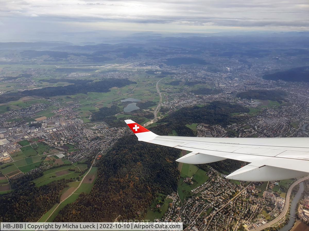 HB-JBB, 2016 Bombardier CSeries CS100 (BD-500-1A10) C/N 50011, Climbing out of Zurich, with a view back to the airport (ZRH-ARN)