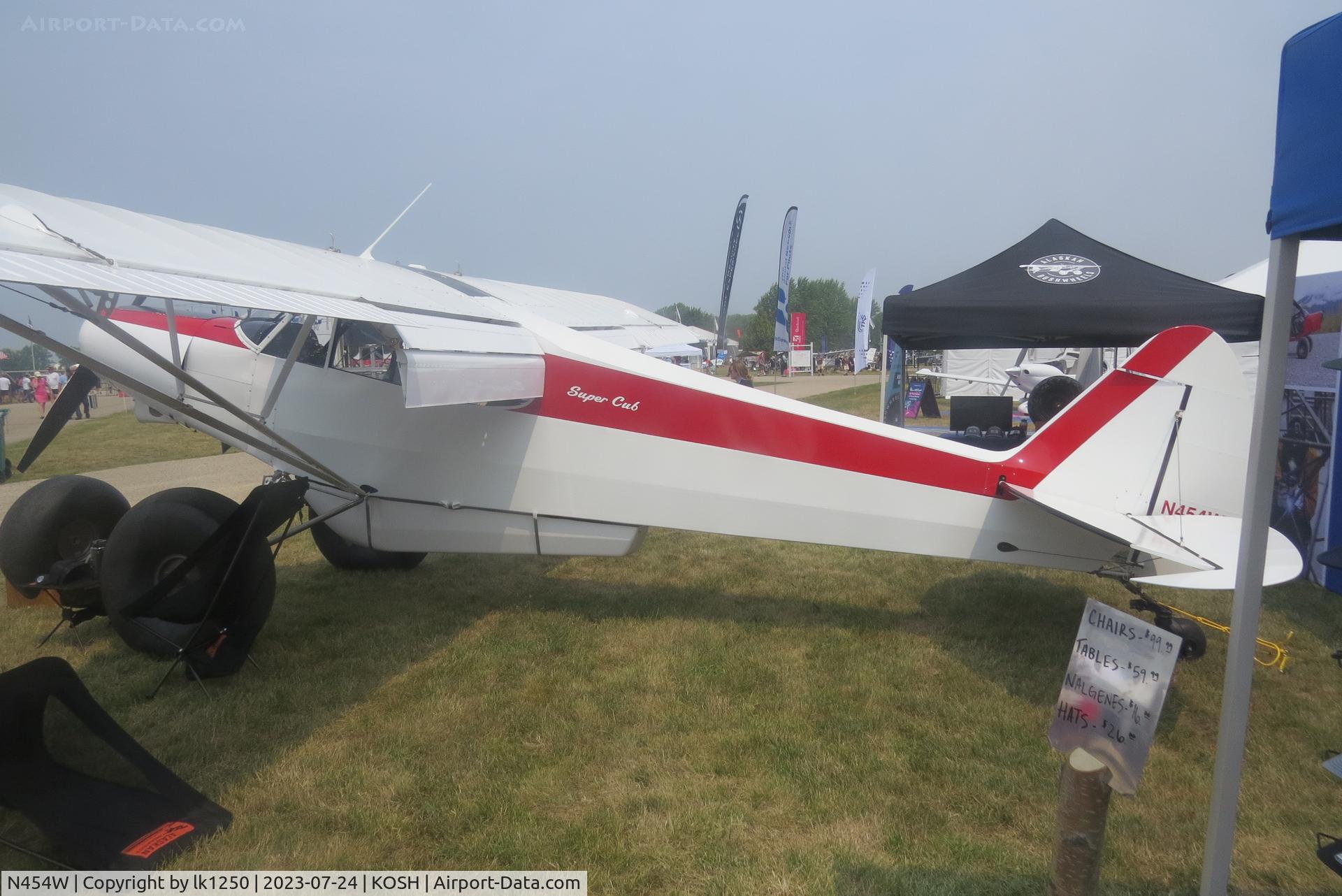 N454W, Piper PA-18-150 Super Cub C/N 18-7909110, This Piper PA18 has specially modified (very big) wheels for landing on sand or other soft material. It was at EAA AirVenture 2023.