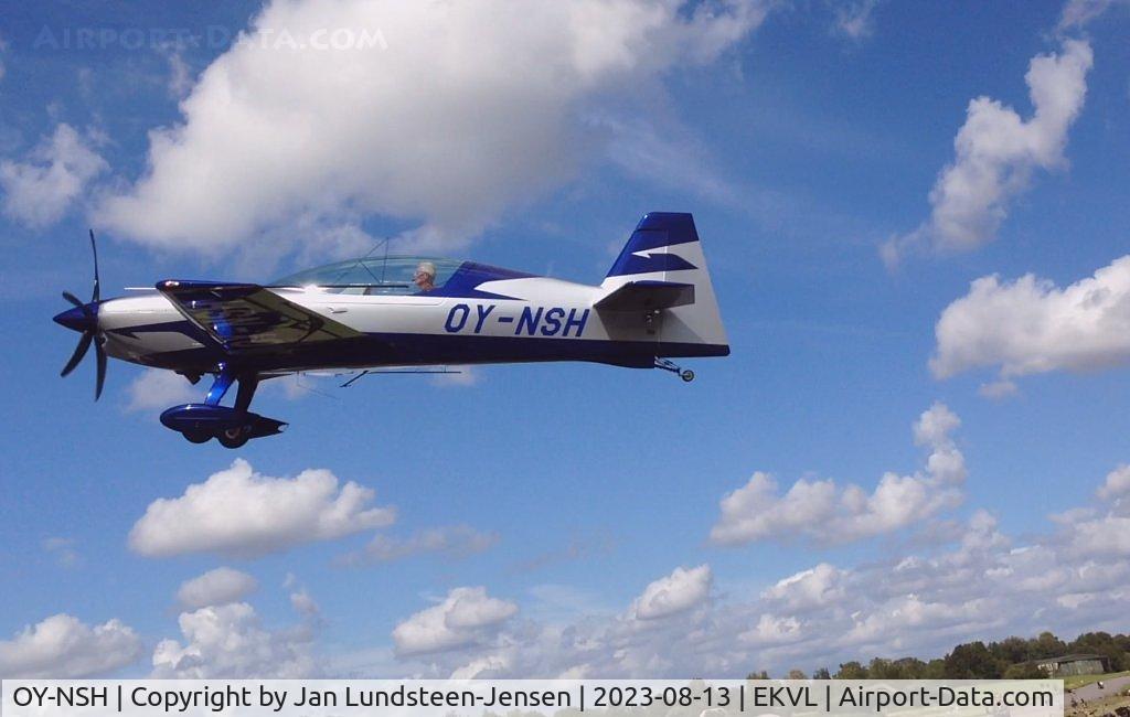 OY-NSH, 2022 Extra NG C/N NG 034, Extra NG  OY-NSH seen on short final to Runway 28 at an 
airshow at Vaerloese, Denmark. Hangar 72 seen in the 
background.