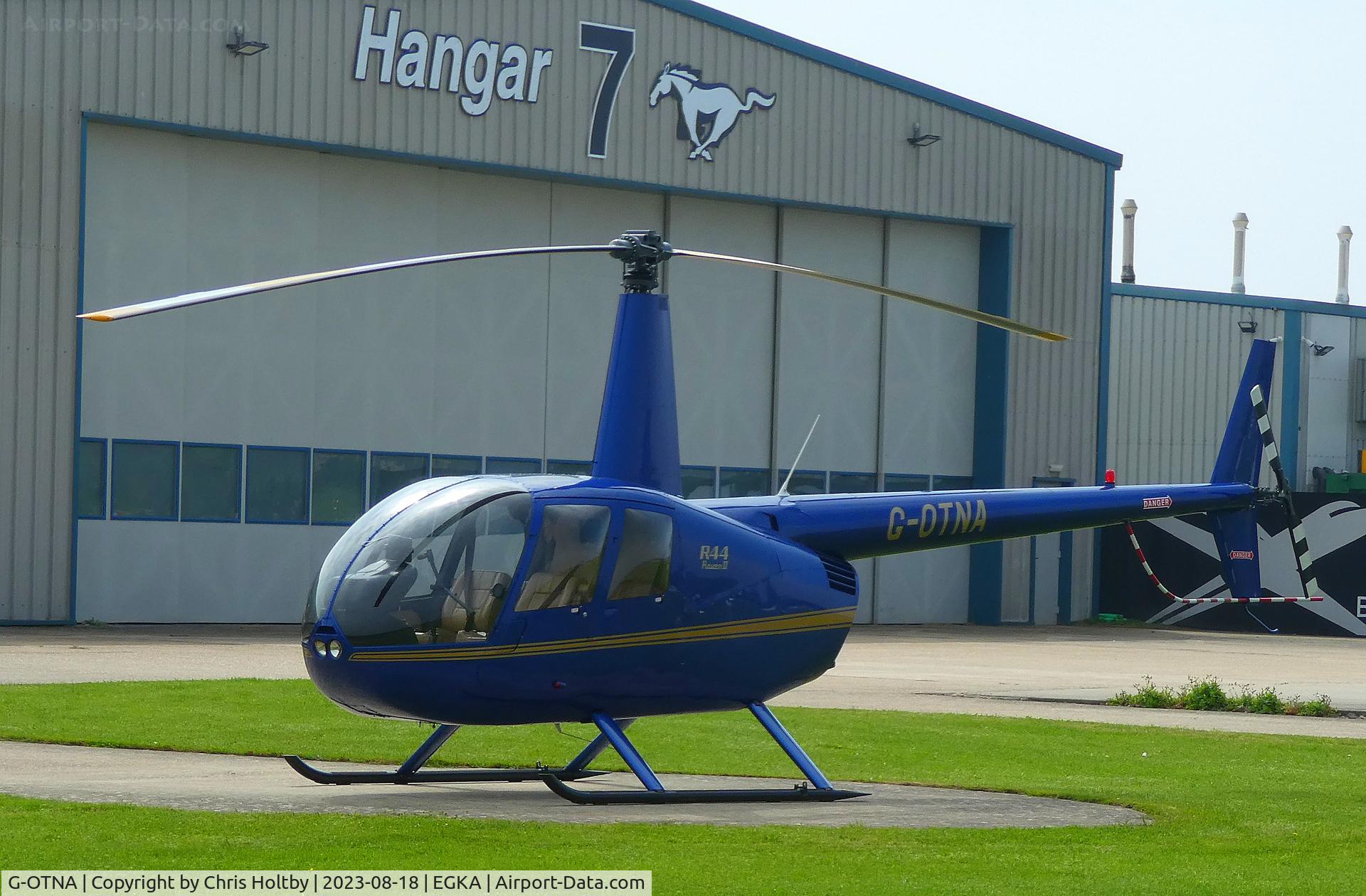 G-OTNA, 2006 Robinson R44 Raven II C/N 11092, Parked outside Hangar 7 at Shoreham Airport, E Sussex