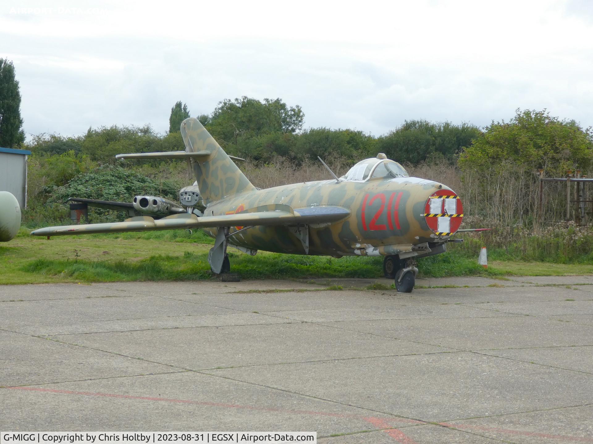 G-MIGG, 1958 PZL-Mielec Lim-5 (MiG-17F) C/N 1C1211, 1958 MiG17F stored at North Weald outside Hangar 4 with its nose covered in legal demands for the owner to collect and pay.
