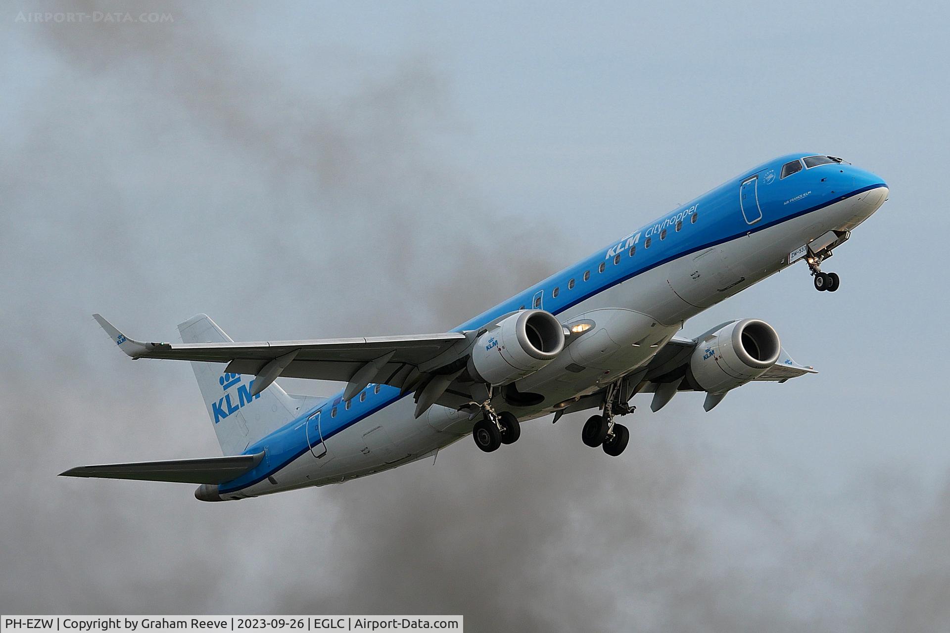 PH-EZW, 2012 Embraer 190LR (ERJ-190-100LR) C/N 19000533, Departing through the smoke of a near by fire from London City Airport.