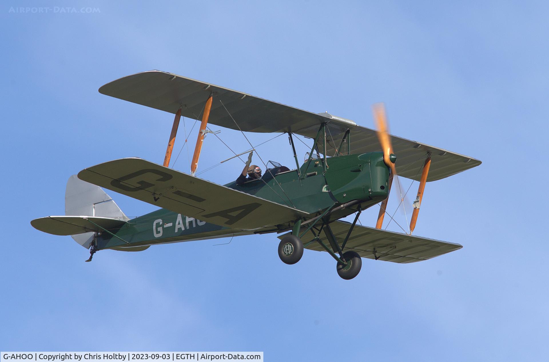 G-AHOO, 1943 De Havilland DH-82A Tiger Moth II C/N 86149, Tiger Moth pilot giving a wave to acknowledge the applause from the crowd at the Vintage Airshow, Old Warden 2023
