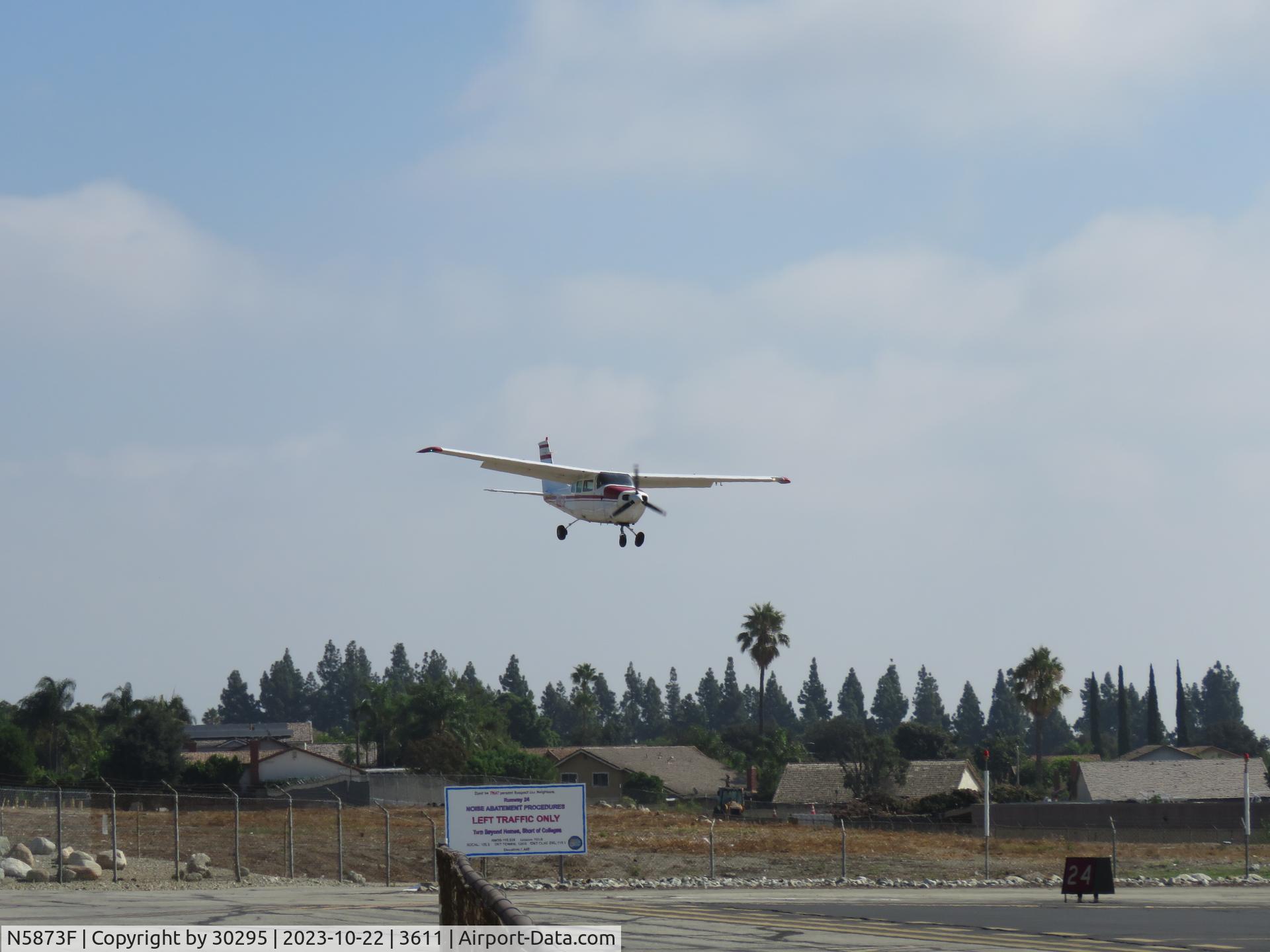 N5873F, 1967 Cessna 210G Centurion C/N 21058873, Nearing the fence