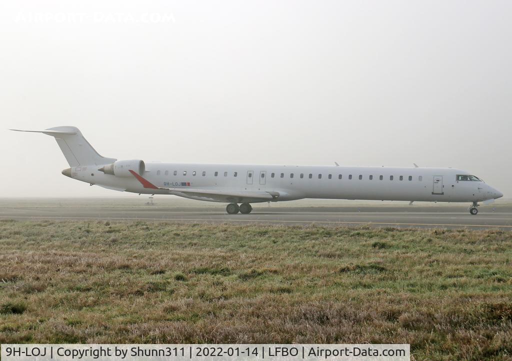 9H-LOJ, 2011 Bombardier CRJ-1000ER NG (CL-600-2E25) C/N 19018, Taxiing holding point rwy 14R for departure... Operated by Mel Air
