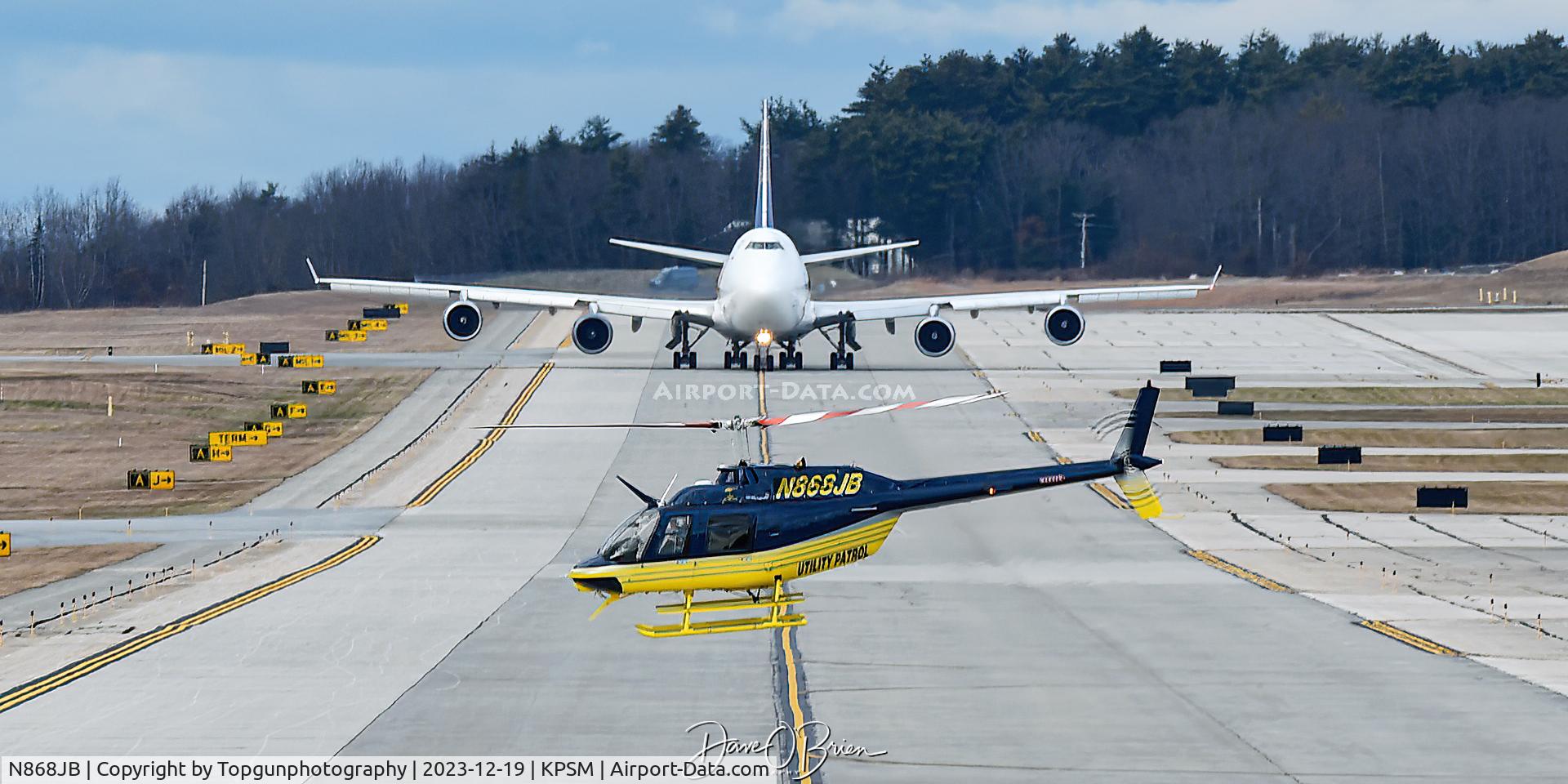 N868JB, 2000 Bell 206B C/N 4534, Utility Line helo heads off after filling up while an Atlas 747 comes down the Alpha Taxiway