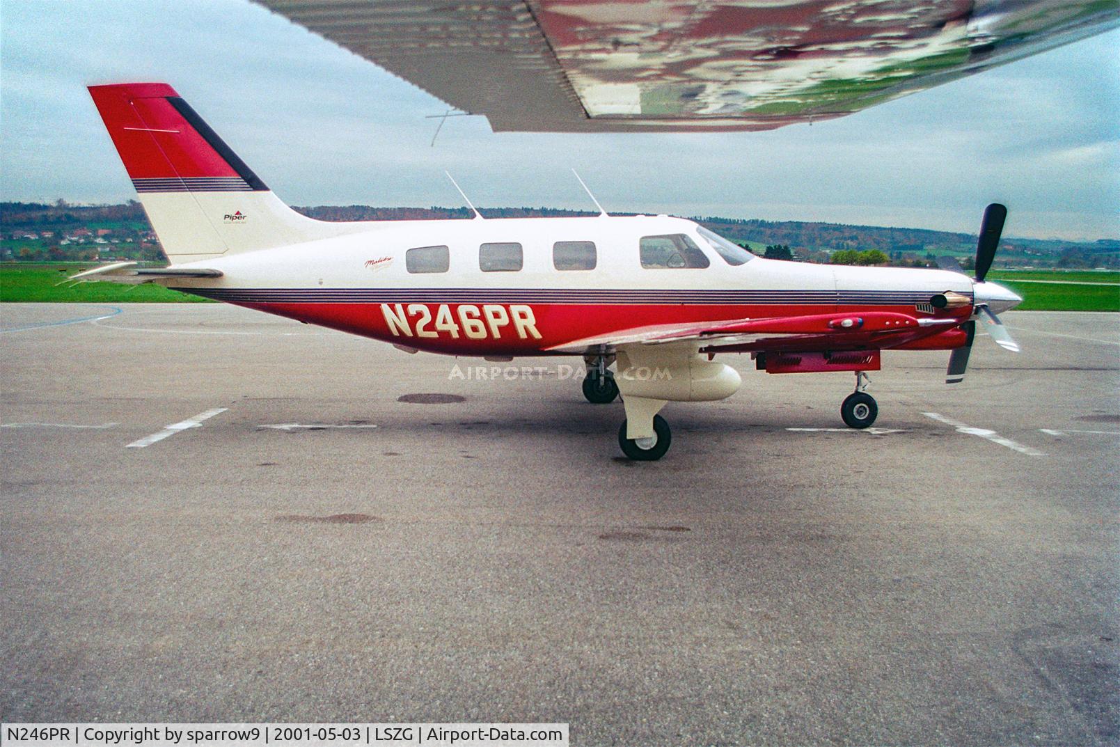 N246PR, 1996 Piper PA-46-350P Malibu Mirage C/N 4636063, Below the wing of the DC-3 at Grenchen. Scanned from a slide.