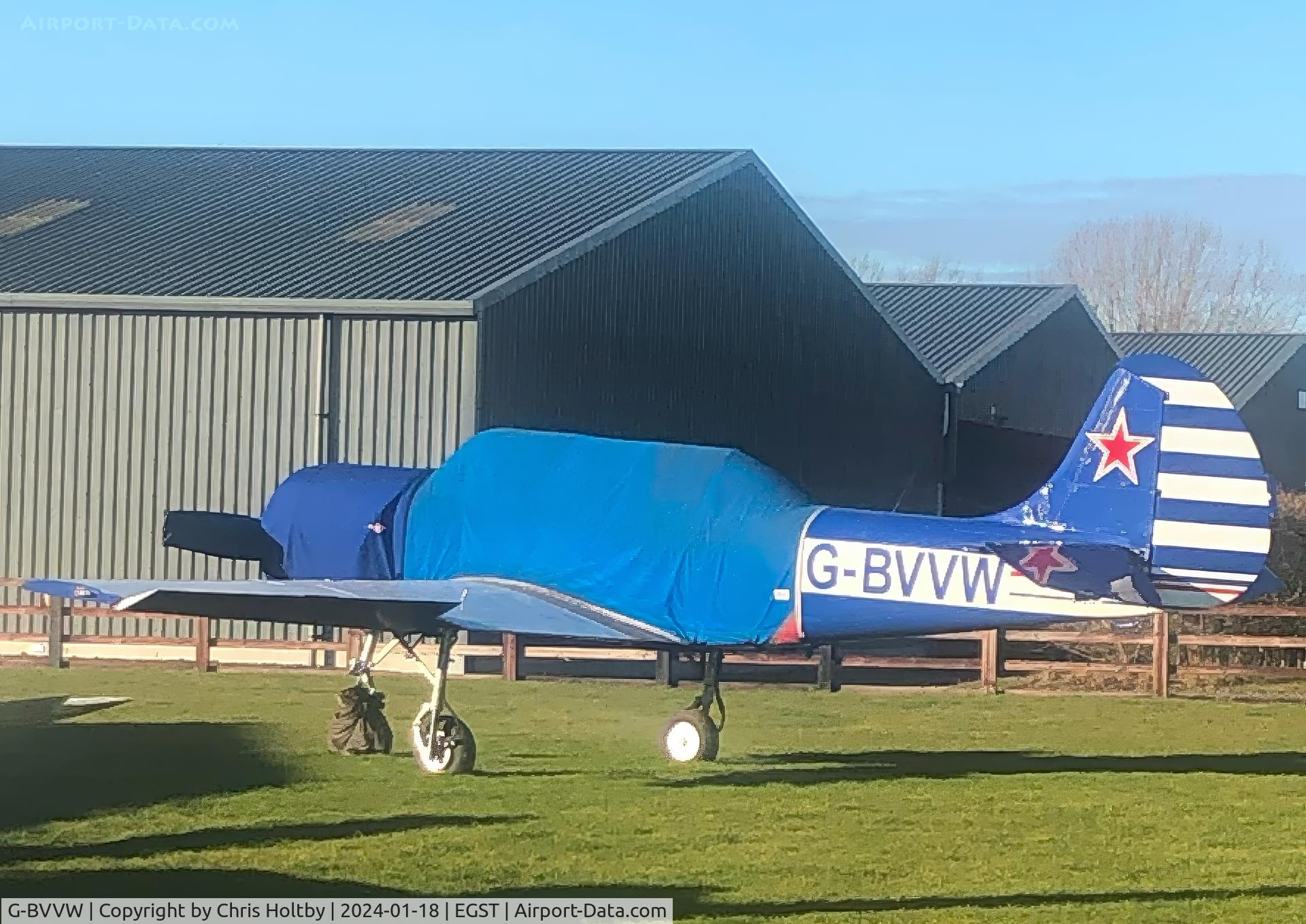 G-BVVW, 1984 Bacau Yak-52 C/N 844605, Yak-52 parked and covered at its base in Elmsett Airfield, Ipswich.