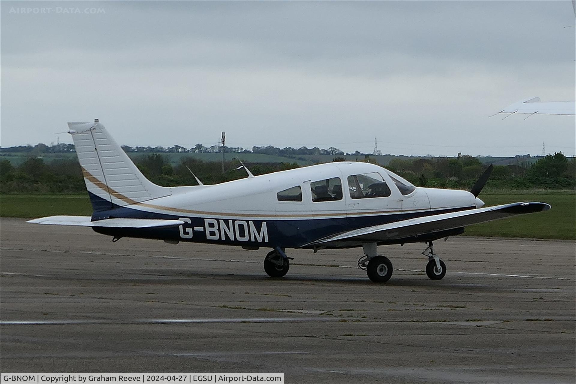 G-BNOM, 1987 Piper PA-28-161 Cherokee Warrior II C/N 2816024, Parked at Duxford.