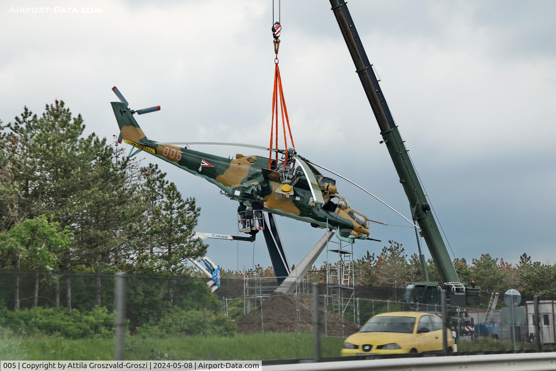 005, 1983 Mil Mi-24D Hind C/N 340275, Displayed as a memorial on the road leading to the former Szentkirályszabadjai Airport. It was given page number 005 in memory of the first Mi-24 combat helicopter to arrive in Hungary. Installation moments.