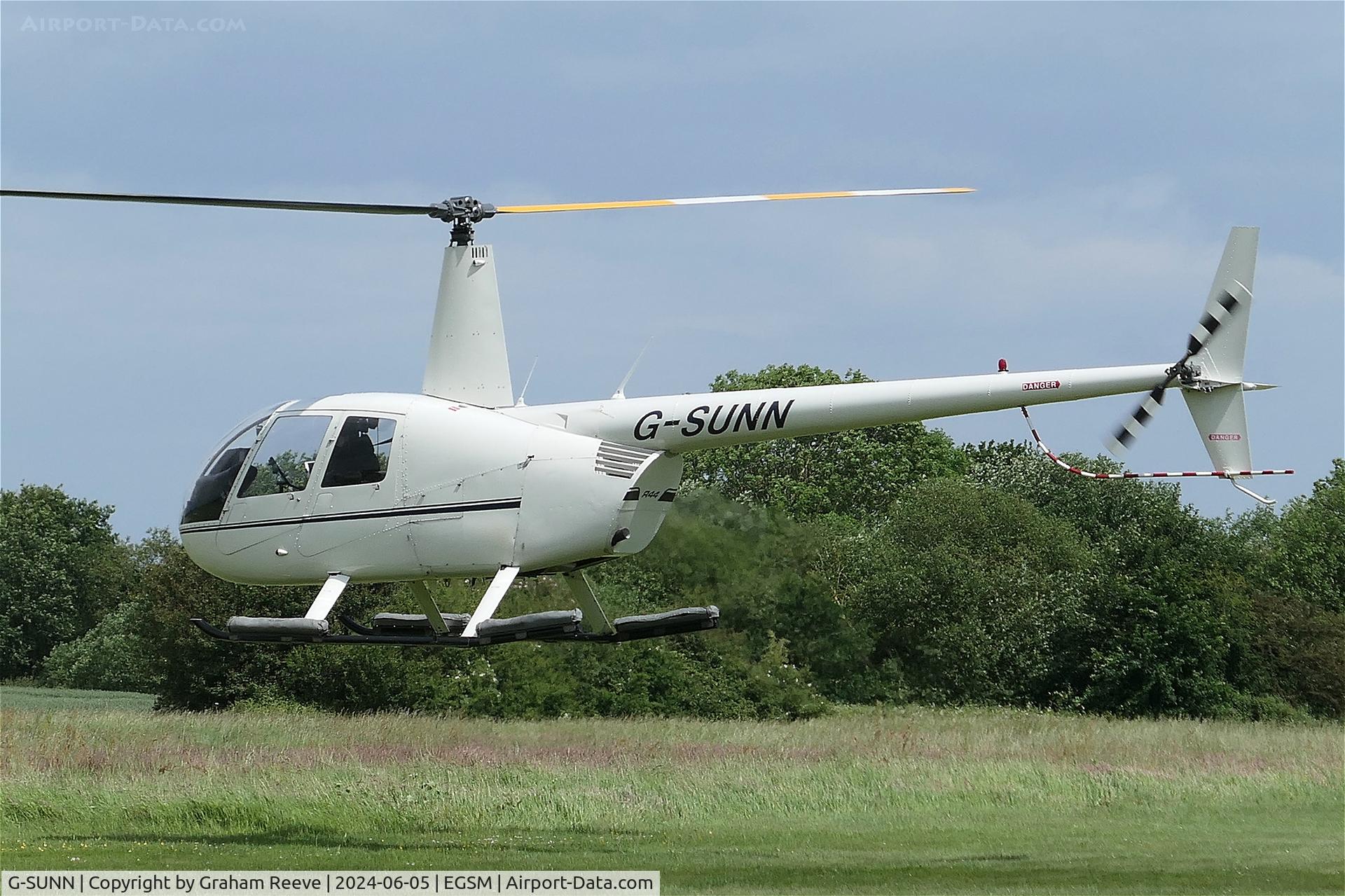 G-SUNN, 2004 Robinson R44 Clipper C/N 1367, Departing from Beccles.