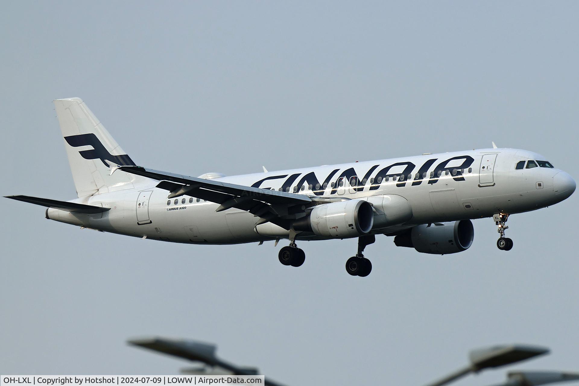 OH-LXL, 2003 Airbus A320-214 C/N 2146, Approaching 16 above light poles of parking lot C