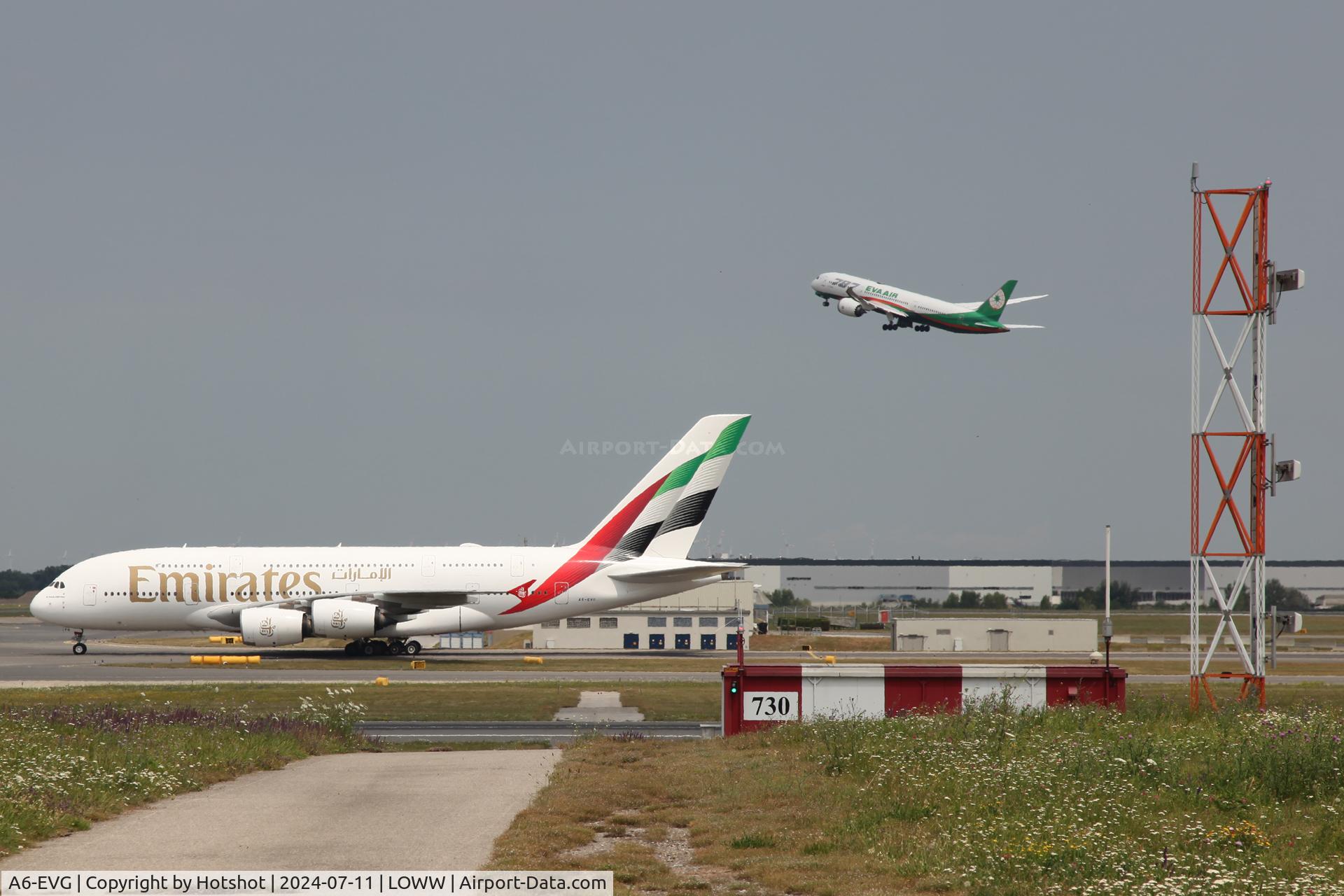 A6-EVG, 2018 Airbus A380-842 C/N 256, Taxiing in on L after landing on runway 34 with EVA Air Dreamliner departing from runway 34 in the backdrop