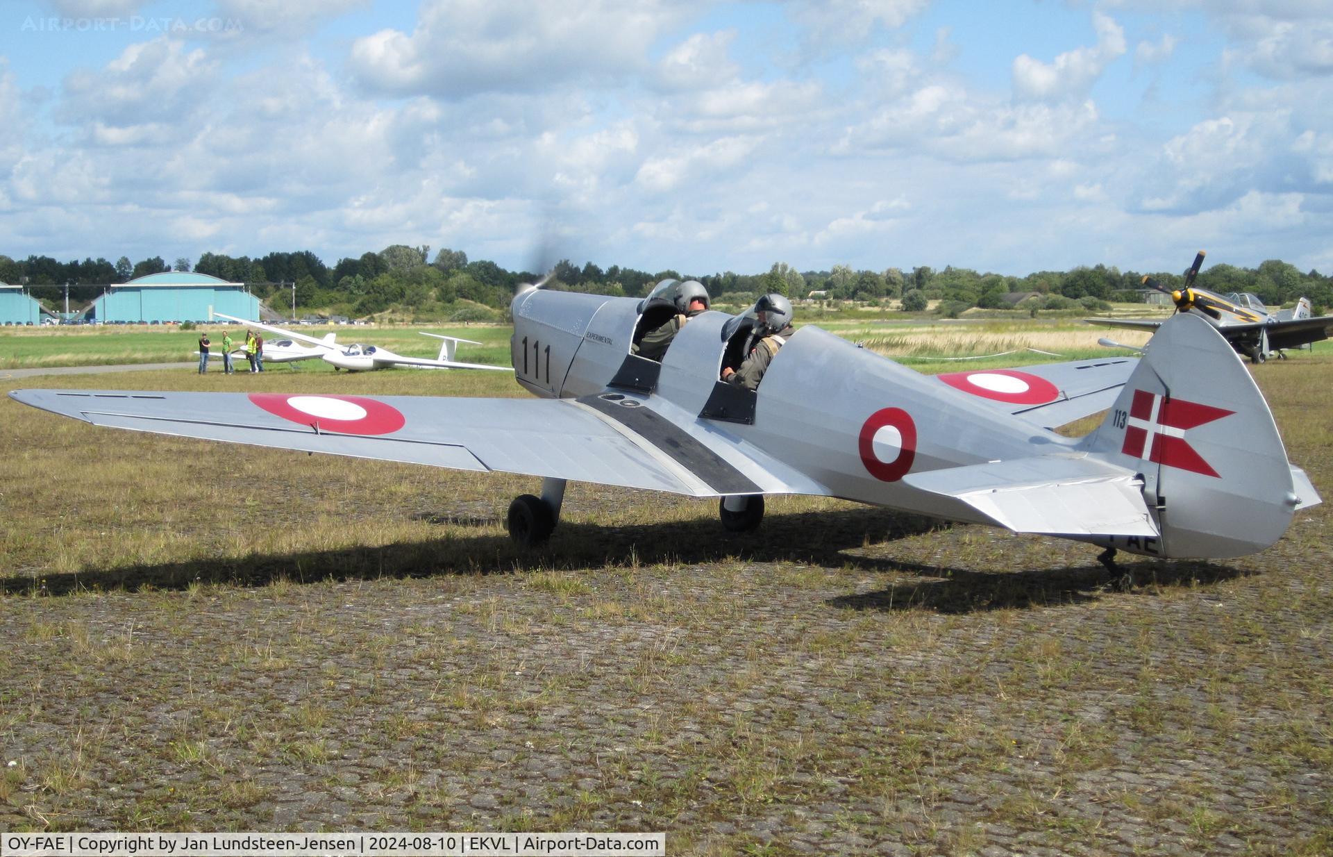 OY-FAE, 1946 SAI KZ IIT Traener C/N 119, Engine running and pilots preparing for a flight at an airshow at Vaerloese in Denmark. KZ IIT is a Danish designed and built aircraft. 15 were used as trainers by Danish Air Force 1946-1955. OY-FAE is ex Danish AF 119, 11-111.