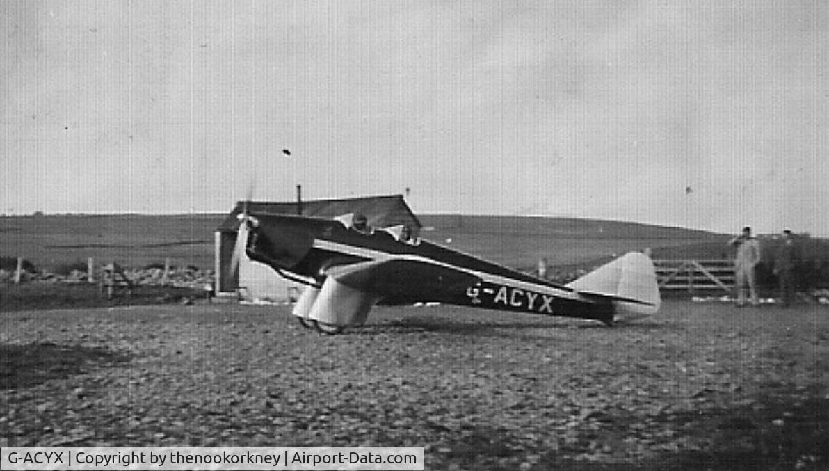 G-ACYX, 1934 Miles M.2H Hawk Major C/N 129, A scanned copy taken at Wideford Aerodrome, just outside Kirkwall in Orkney.  The aerodrome was a grass strip and was better known when used by Captain EE (Ted) Fresson for his airline, Highland Airways.  This photo was taken before Kirkwall Airport.