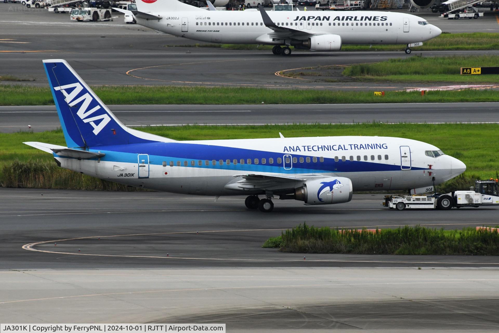 JA301K, 1997 Boeing 737-54K C/N 27435, ANA training aircraft being towed across the field