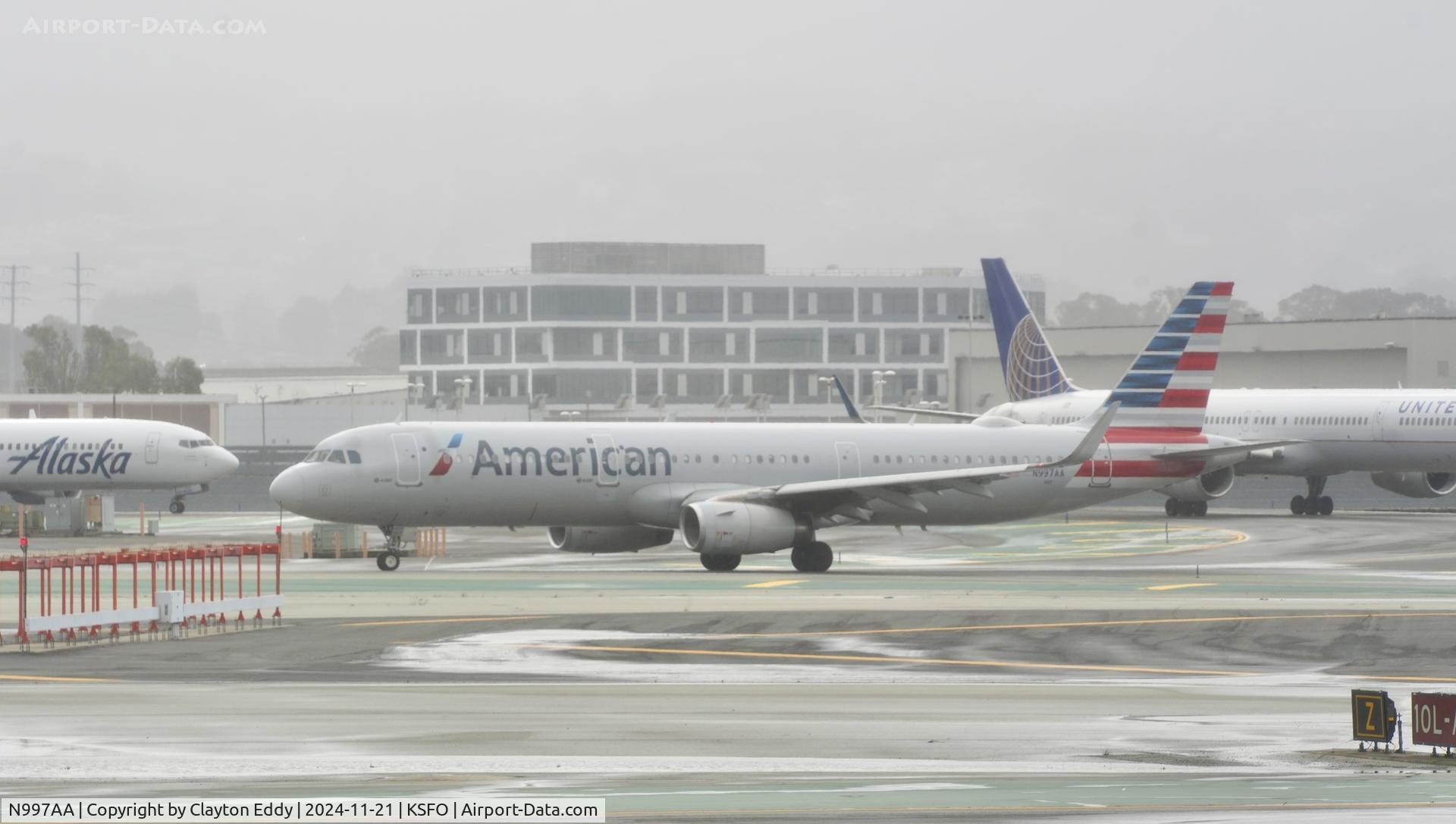 N997AA, 2017 Airbus A321-231 C/N 7349, Departing runway 10, November rain, 'Pineapple Express' SFO 2024.