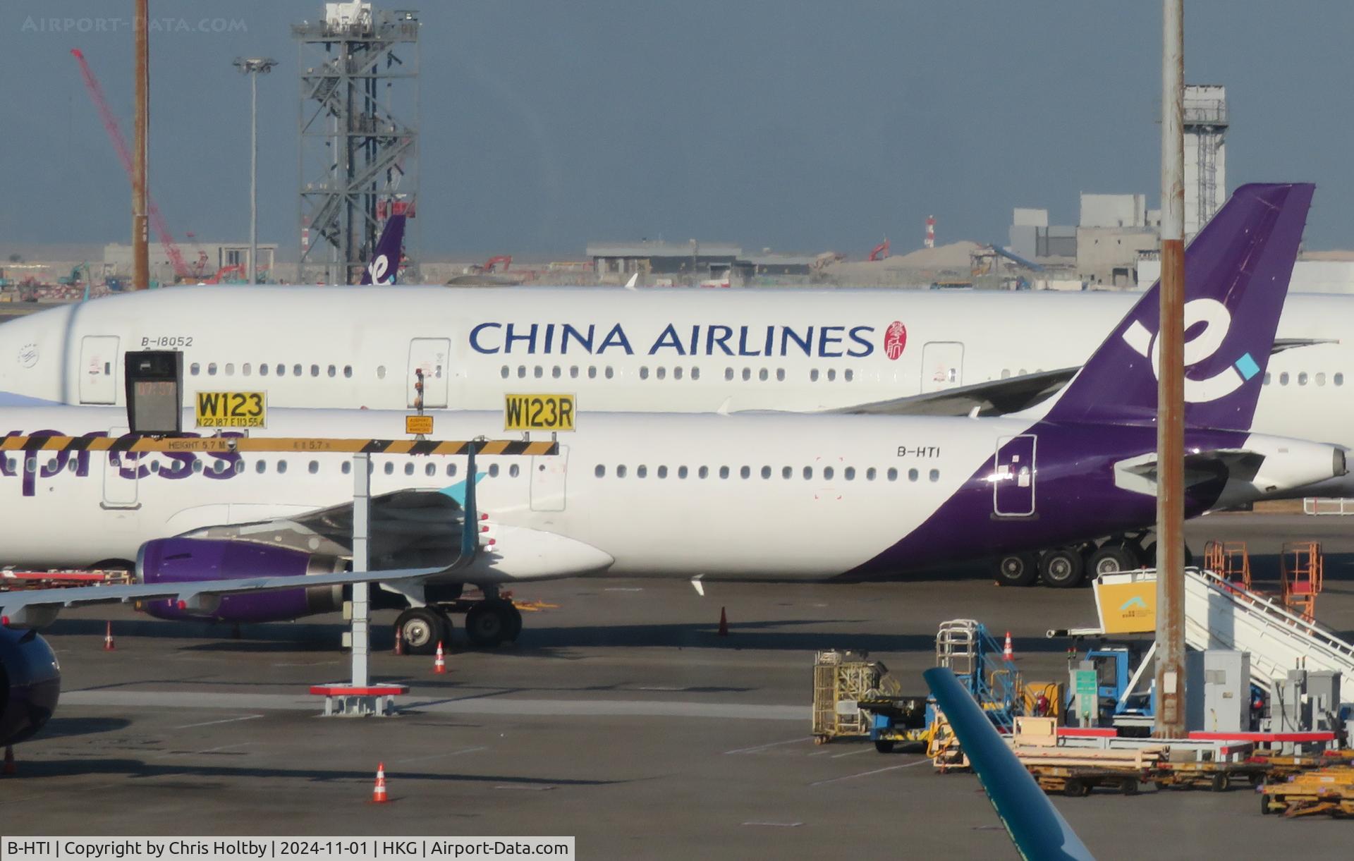 B-HTI, 2003 Airbus A321-231 C/N 2021, Parked at Hong Kong International in its new Hong Express Airways livery