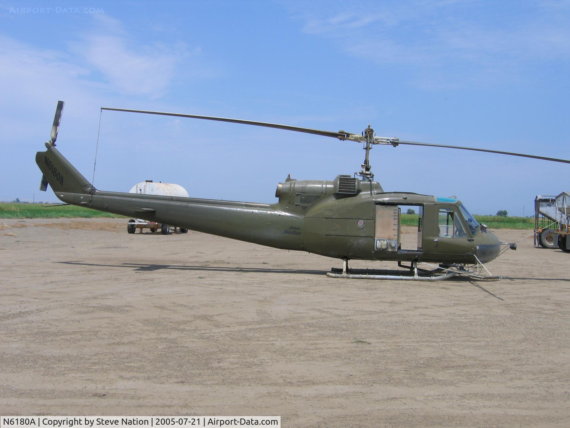 N6180A, 1962 Bell UH-1B C/N 62-1994, Jones Flying Service 1962 Bell UH-1B (62-1994) as sprayer at JFS Williams, CA airstrip