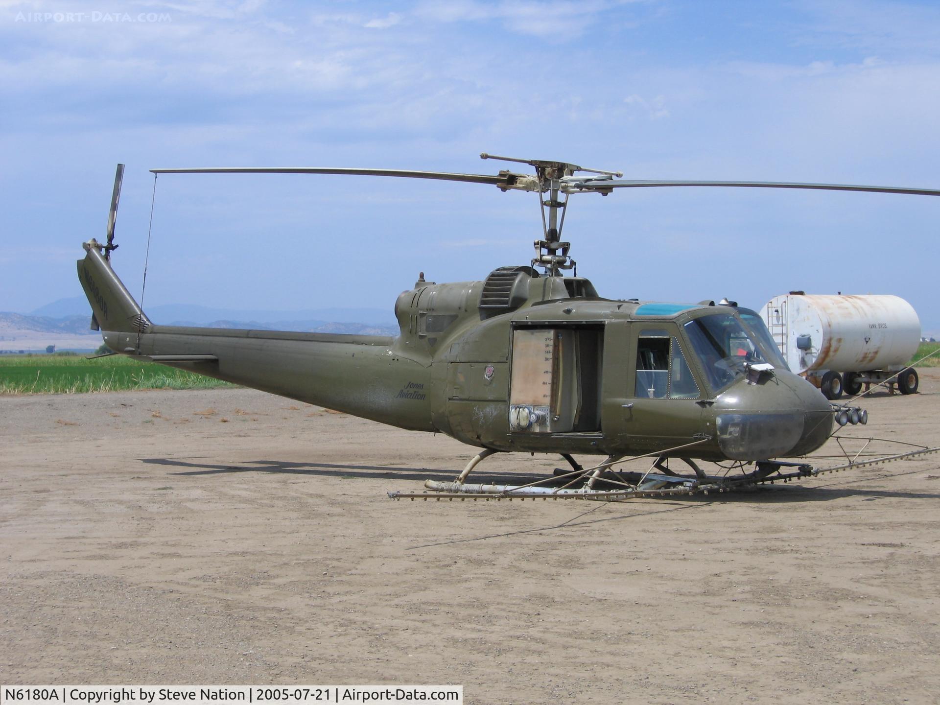 N6180A, 1962 Bell UH-1B C/N 62-1994, Jones Flying Service 1962 Bell UH-1B (62-1994) as sprayer at JFS Williams, CA airstrip