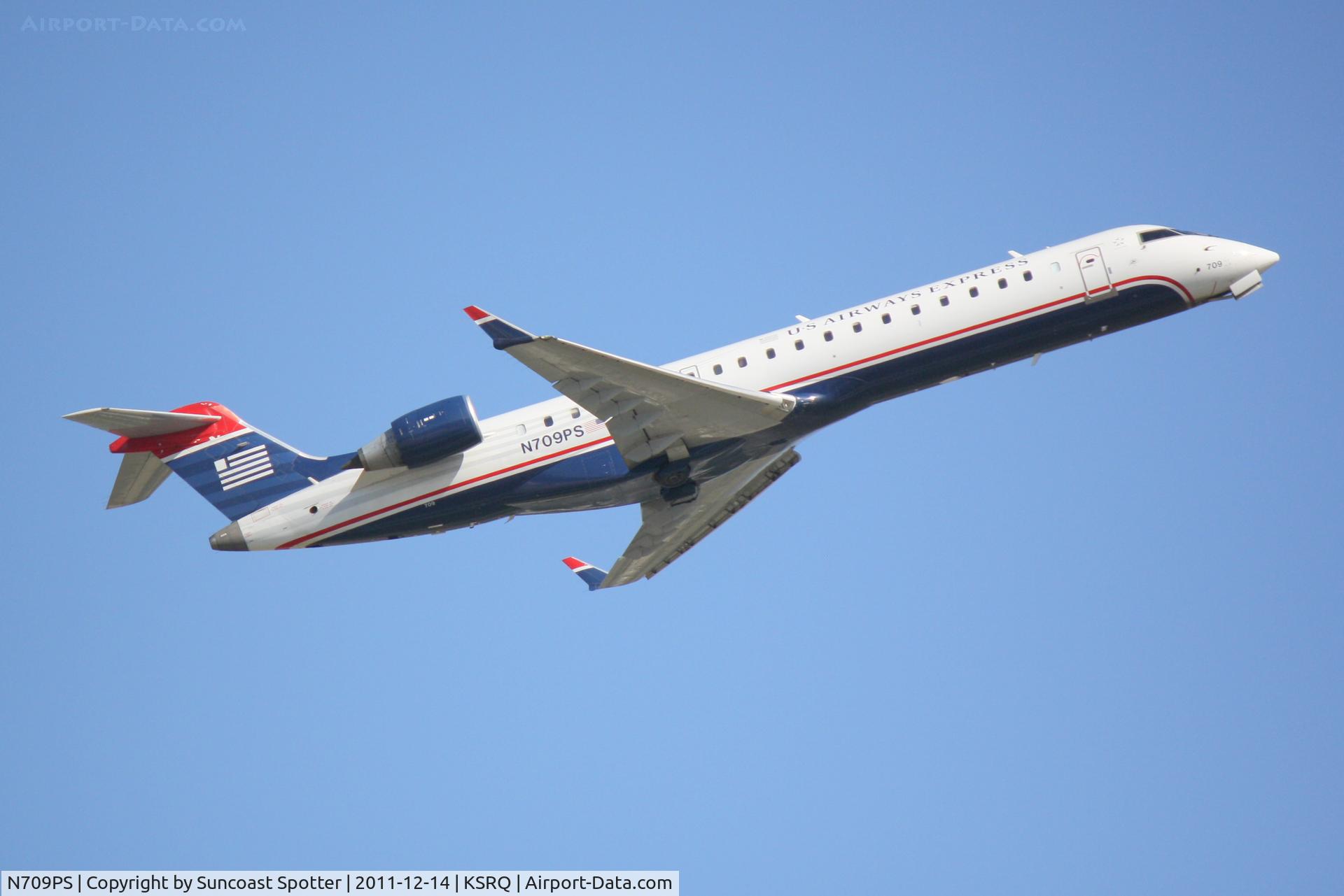 N709PS, 2004 Bombardier CRJ-701 (CL-600-2C10) Regional Jet C/N 10165, PSA Airlines/US Airways Express CRJ-700 departs from Runway 14 at Sarasota-Bradenton International Airport