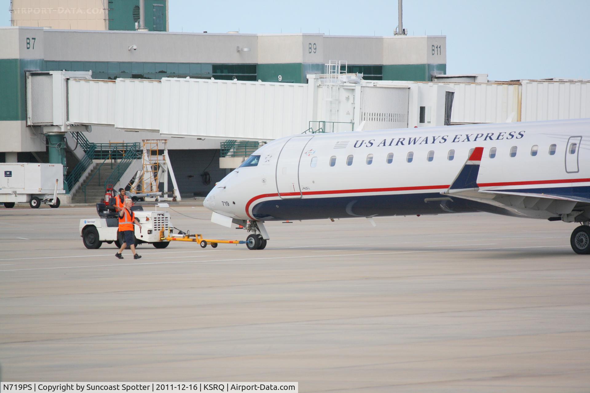 N719PS, 2004 Bombardier CRJ-701 (CL-600-2C10) Regional Jet C/N 10177, PSA Airlines/US Airways Express CRJ-700 pushes back from the gate at Sarasota-Bradenton International Airport
