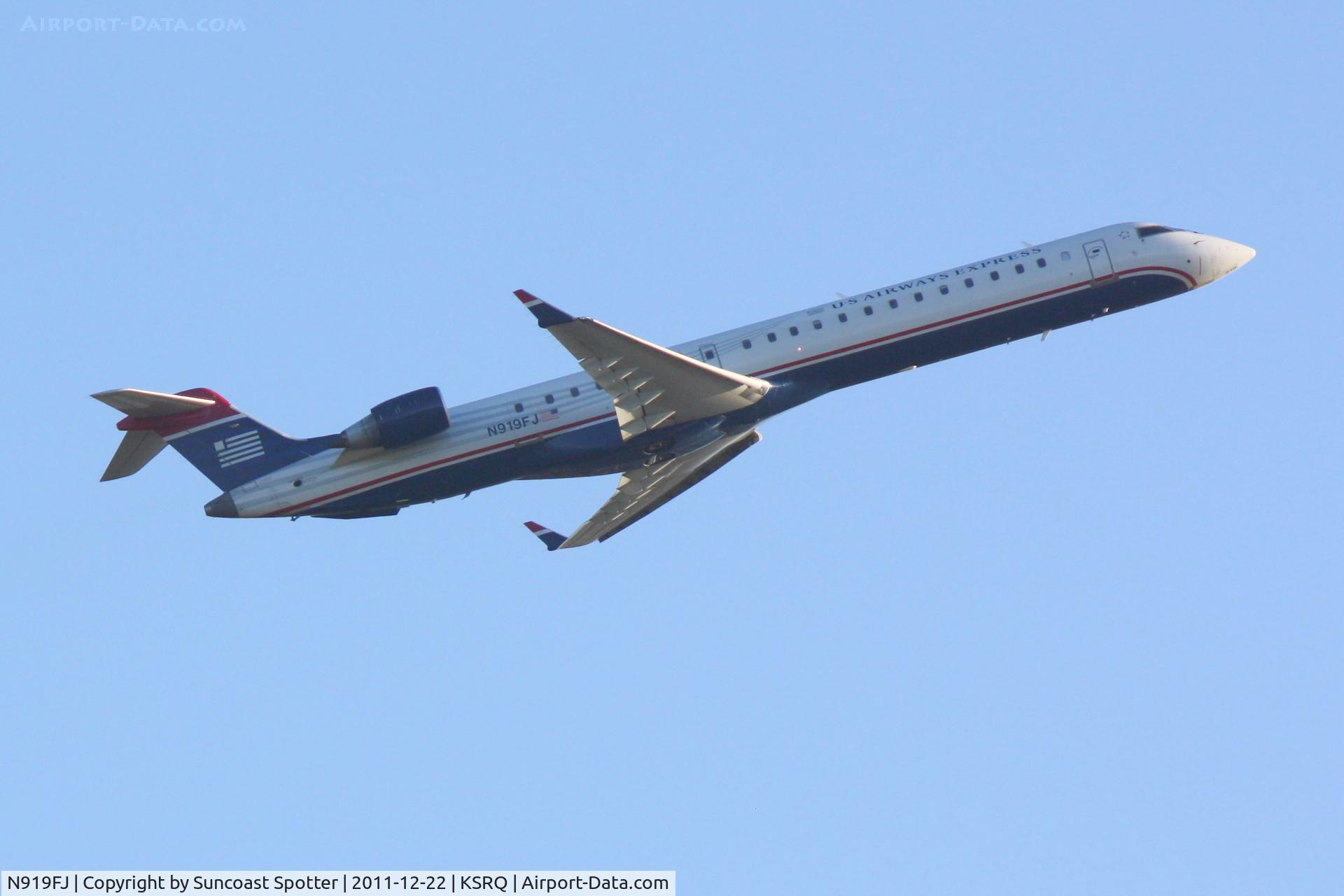 N919FJ, 2004 Bombardier CRJ-900ER (CL-600-2D24) C/N 15019, Mesa Airlines/US Airways Express Flight 2632 departs Runway 14 at Sarasota-Bradenton International Airport enroute to Charlotte/Douglas International Airport