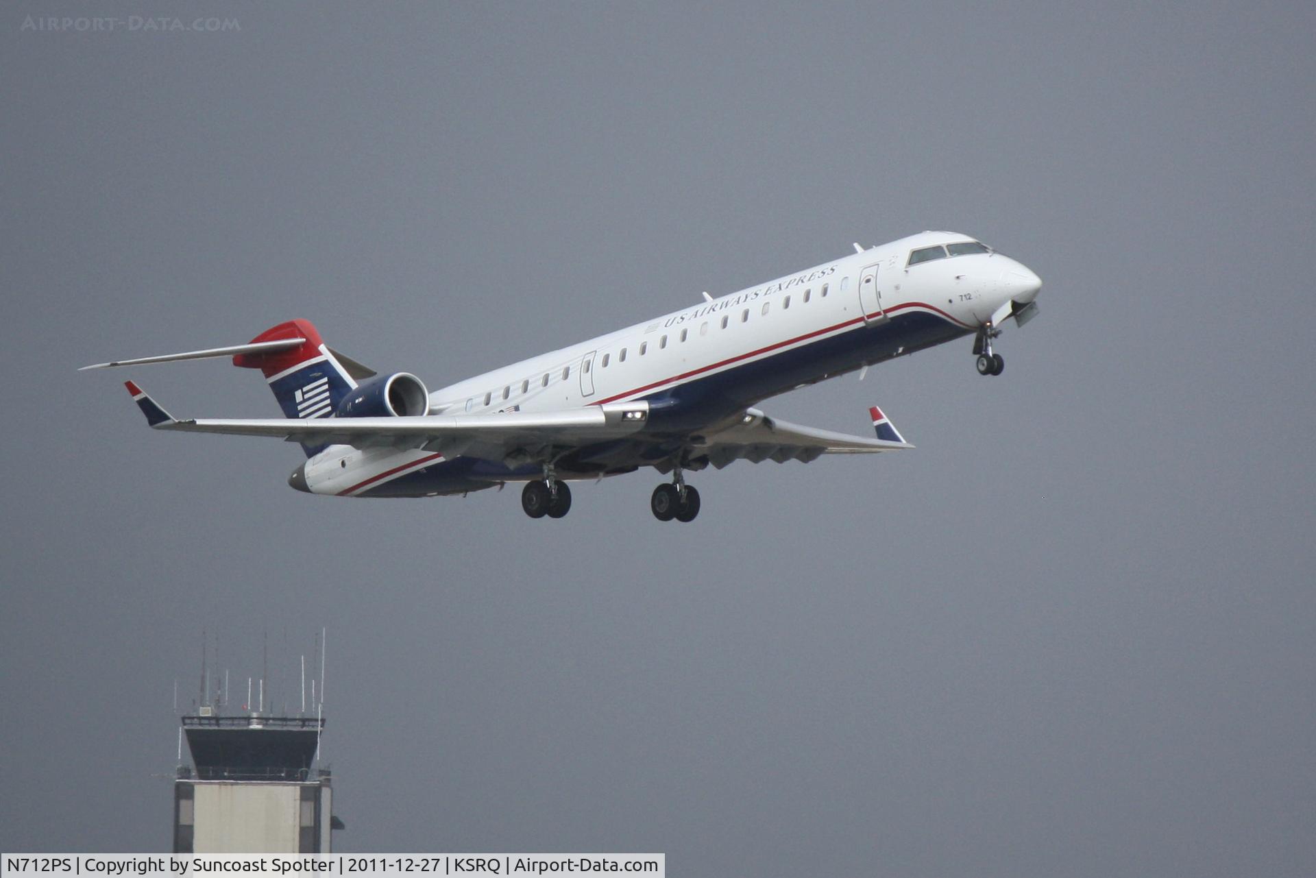N712PS, 2004 Bombardier CRJ-701 (CL-600-2C10) Regional Jet C/N 10168, PSA/US Airways Express Flight 2232 departs Runway 14 at Sarasota-Bradenton International Airport enroute to Charlotte/Douglas International Airport