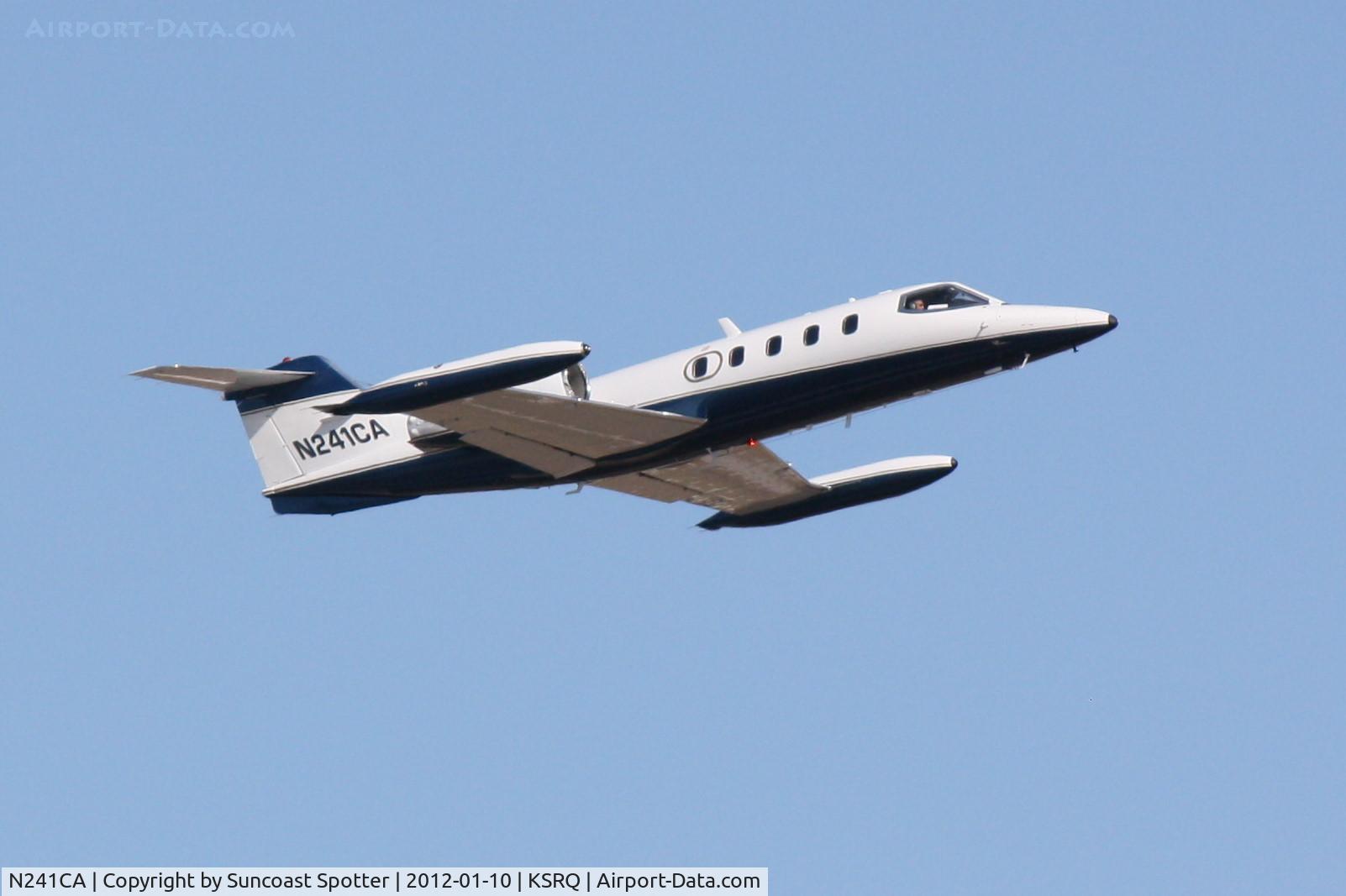 N241CA, 1977 Gates Learjet 35A C/N 142, N241CA departs Runway 14 at Sarasota-Bradenton International Airport enroute to Chicago Executive Airport